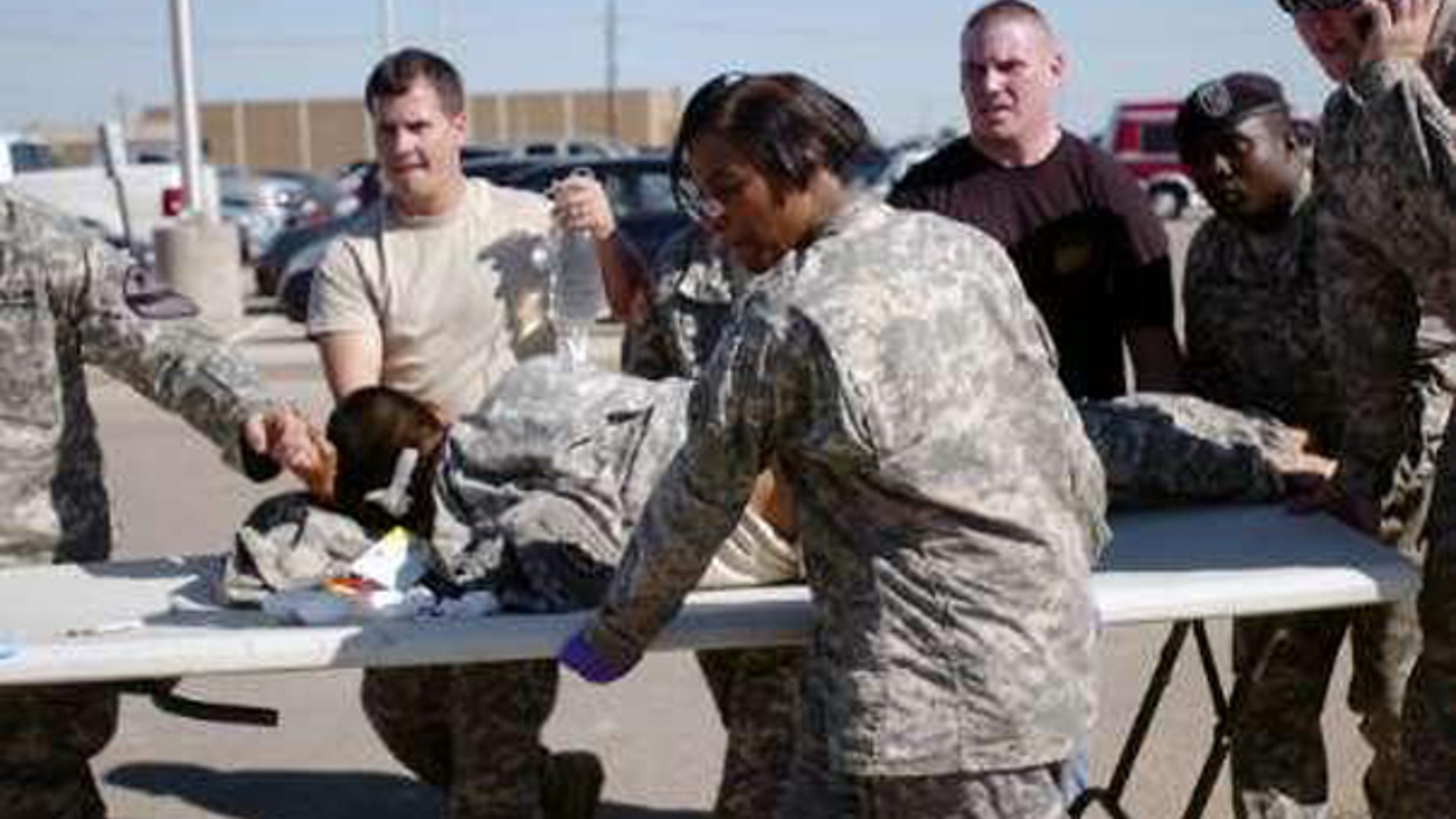 Army first responders use a table as a stretcher to transport a wounded soldier to an ambulance at Fort Hood in 2009. Prosecutors said Mohamed Jalloh had considered launching a Fort Hood-style attack.