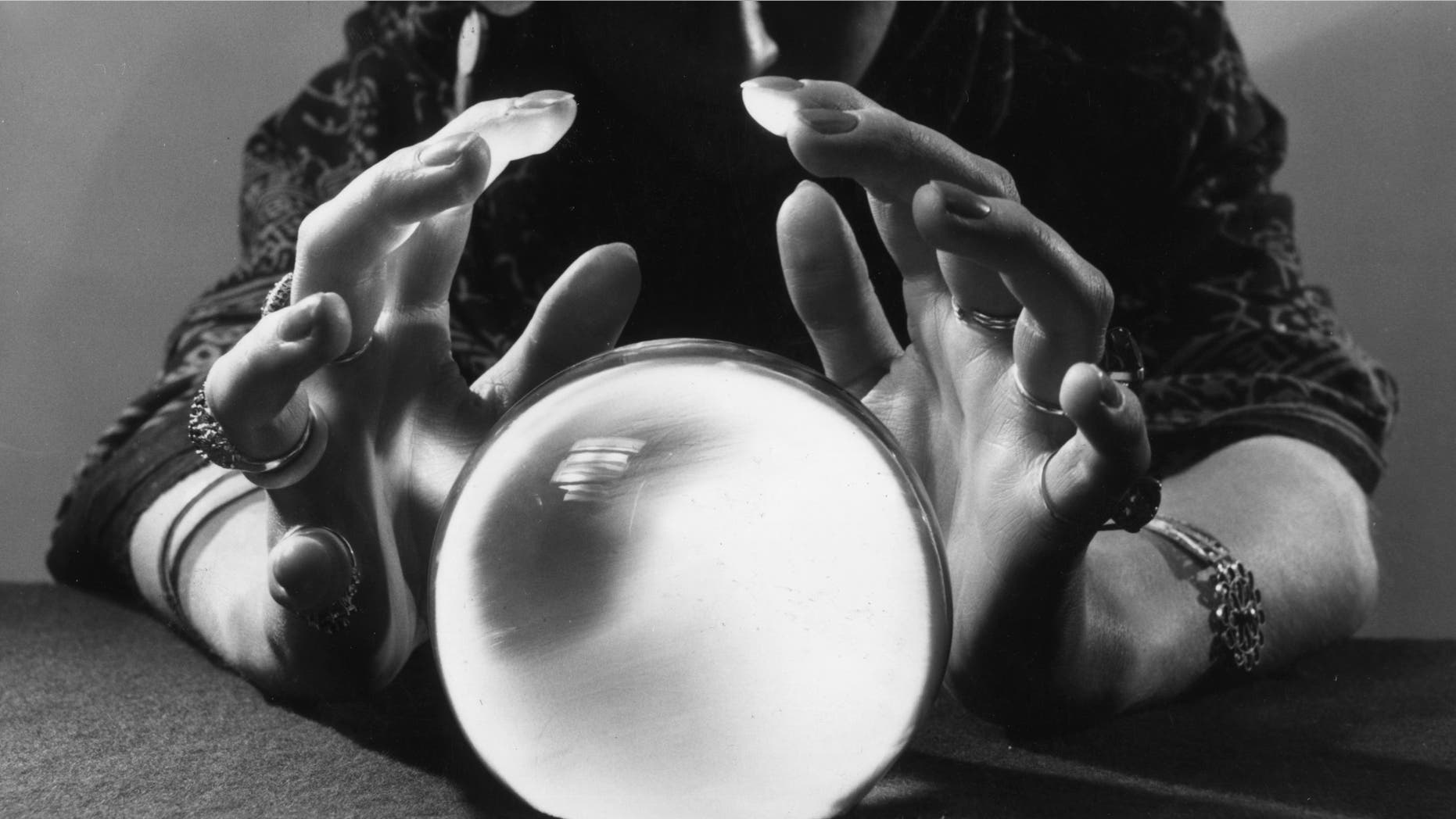 A gypsy fortune-teller gazing into her crystal ball.