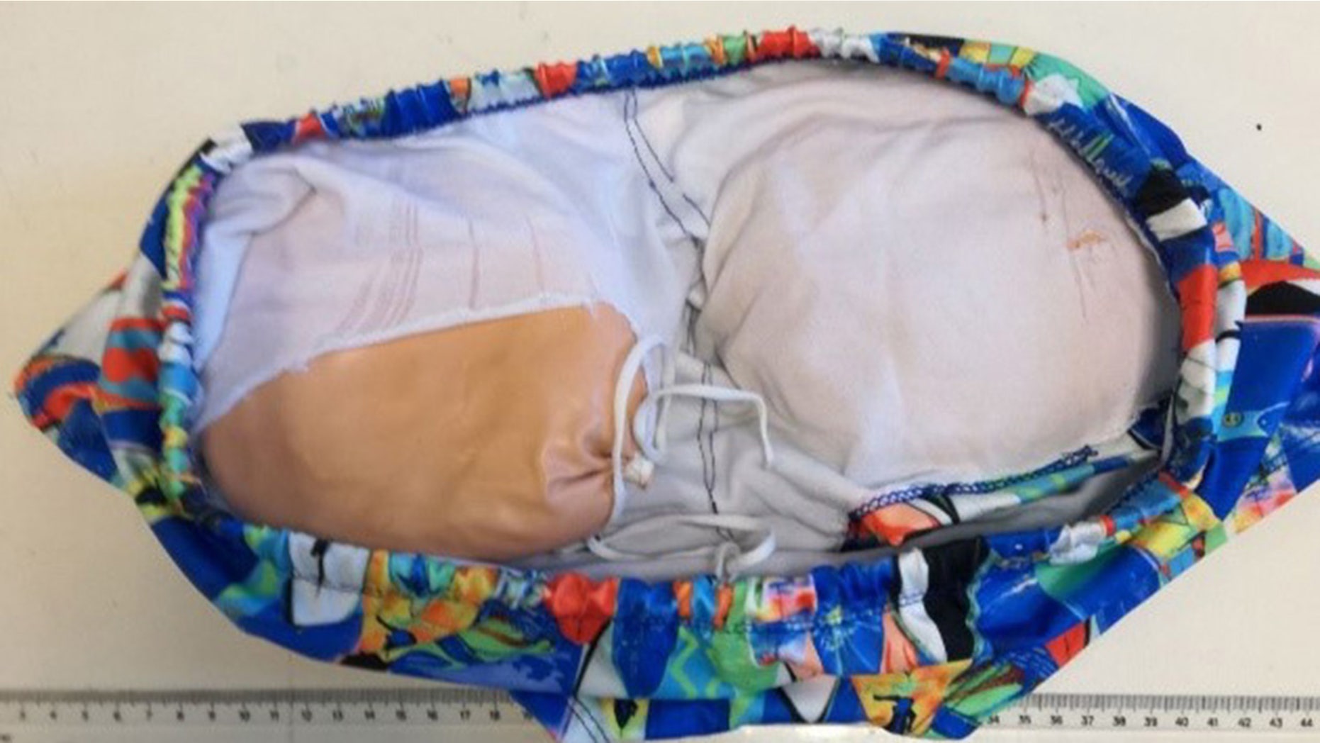 A man used two cushion-like butt implants to try to smuggle more than two pounds of cocaine.