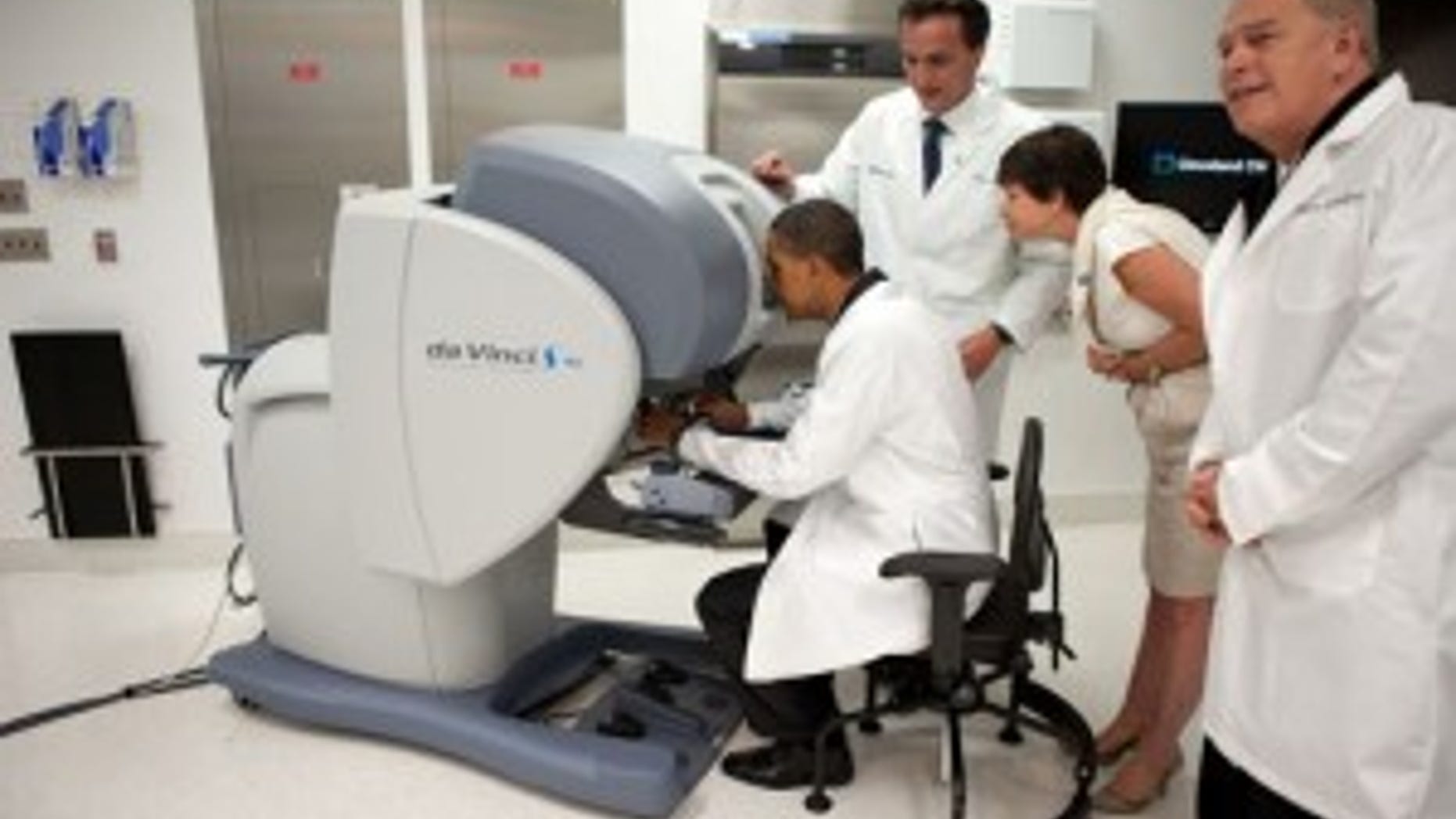 (WH Photo) President Obama tries his hand operating a robotic surgical system while touring the Cleveland Clinic in Ohio.