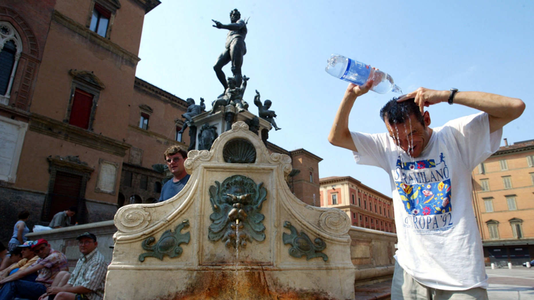 File photo - A tourist refreshes himself in front of the famous Neptune fountain in Bologna, central Italy, August 8, 2003. (Reuters)