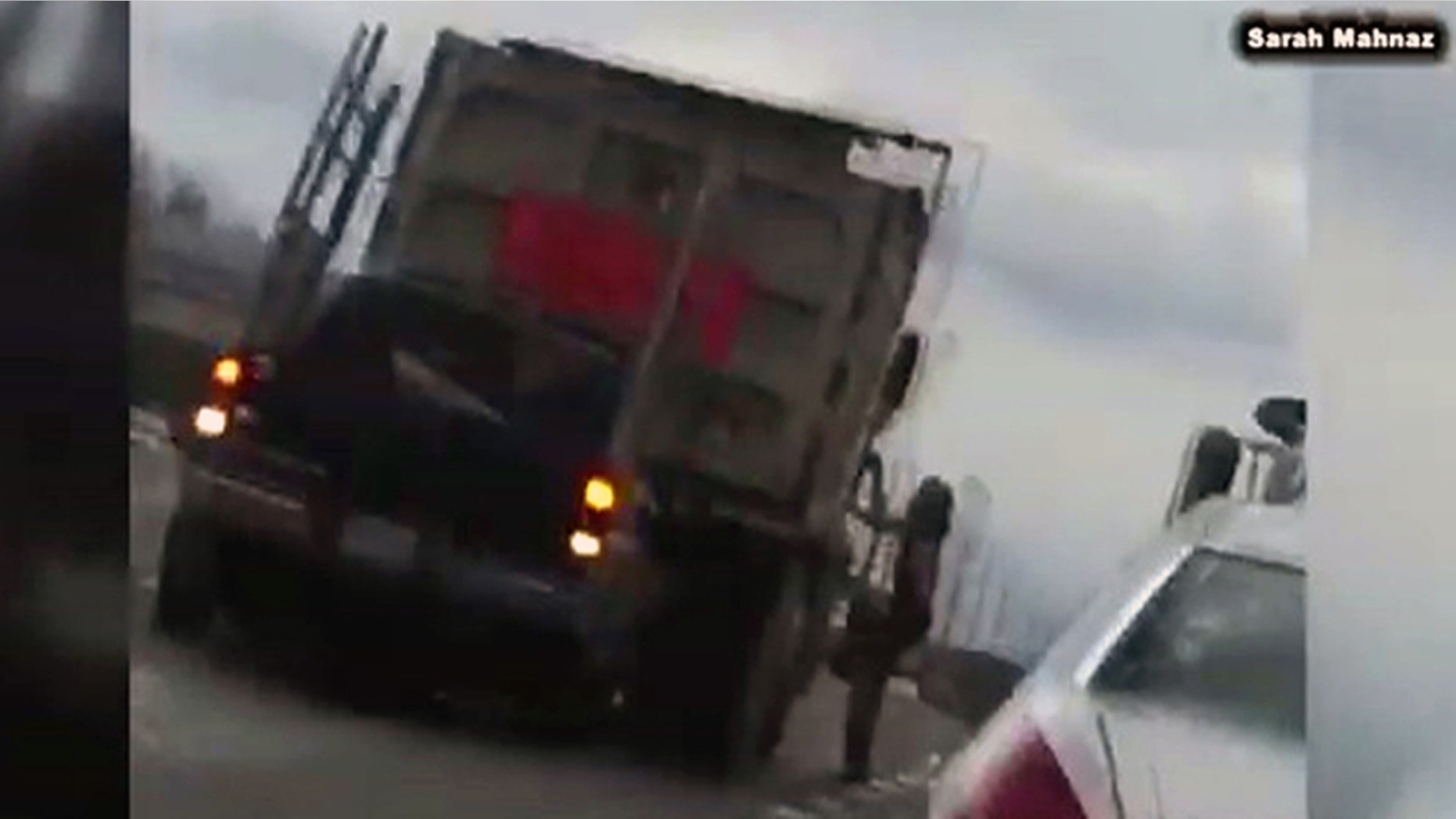 A video shows a naked man running and jumping on multiple vehicles near a roadway outside Washington Dulles International Airport.