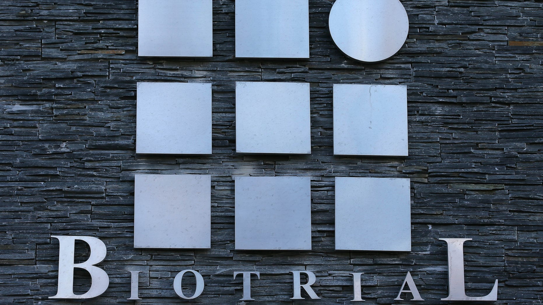 FILE - This Friday, Jan. 15, 2016 file photo shows a logo of the Biotrial laboratory displayed on its building in Rennes, western France. Frances health minister has presented a plan to tighten up the rules regarding human drug trials following an experimental test that killed a volunteer in January. (AP Photo/David Vincent, File)
