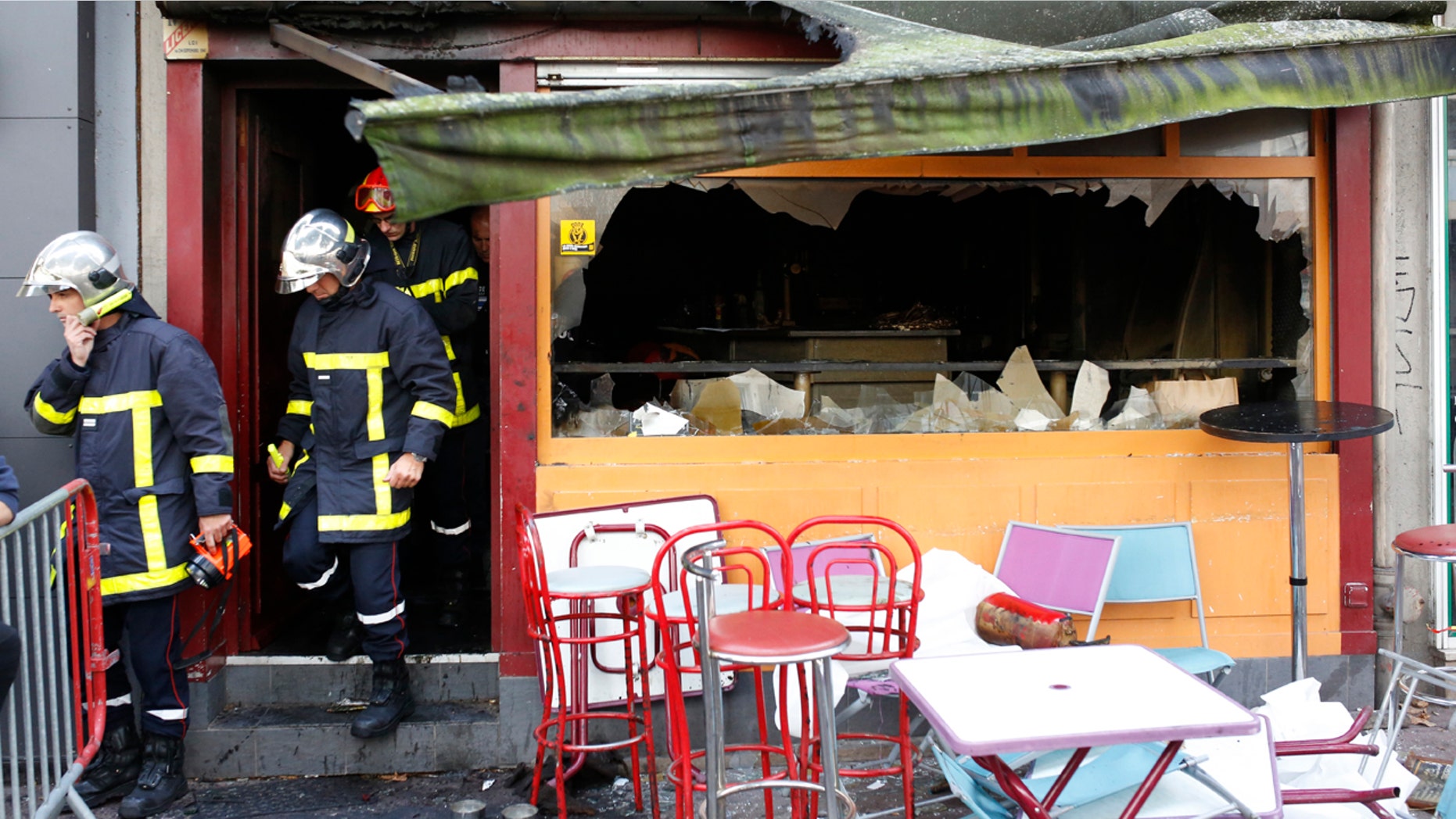 Firefighters leave the bar where a fire broke in Rouen, western France, Saturday Aug.6, 2016. A fire swept through a Friday night birthday party at a bar in the Normandy city of Rouen, killing at least 13 people and injuring six others, French authorities said. (AP Photo/Kamil Zihnioglu)