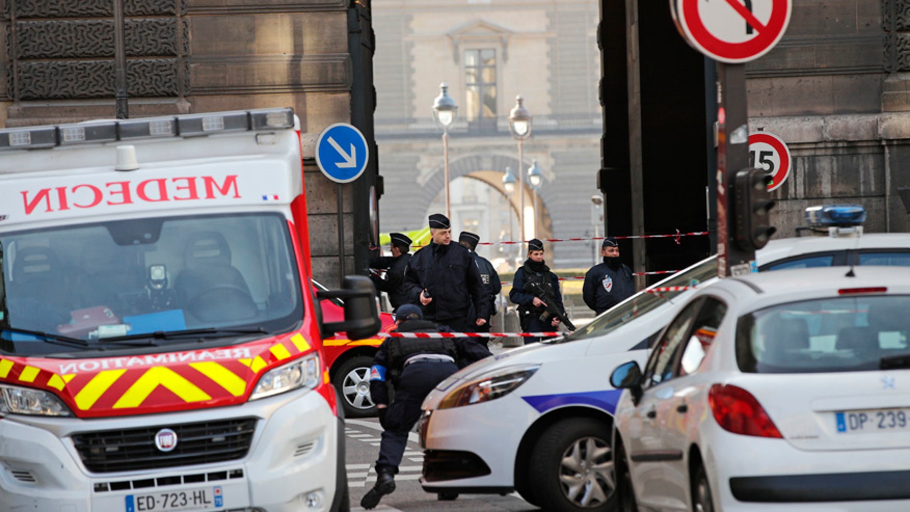 Police officers cordon off the area outside the Louvre museum near where a soldier opened fire after he was attacked in Paris, Friday, Feb. 3, 2017. Police say the soldier opened fire outside the Louvre Museum after he was attacked by someone, and the area is being evacuated. (AP Photo/Christophe Ena)