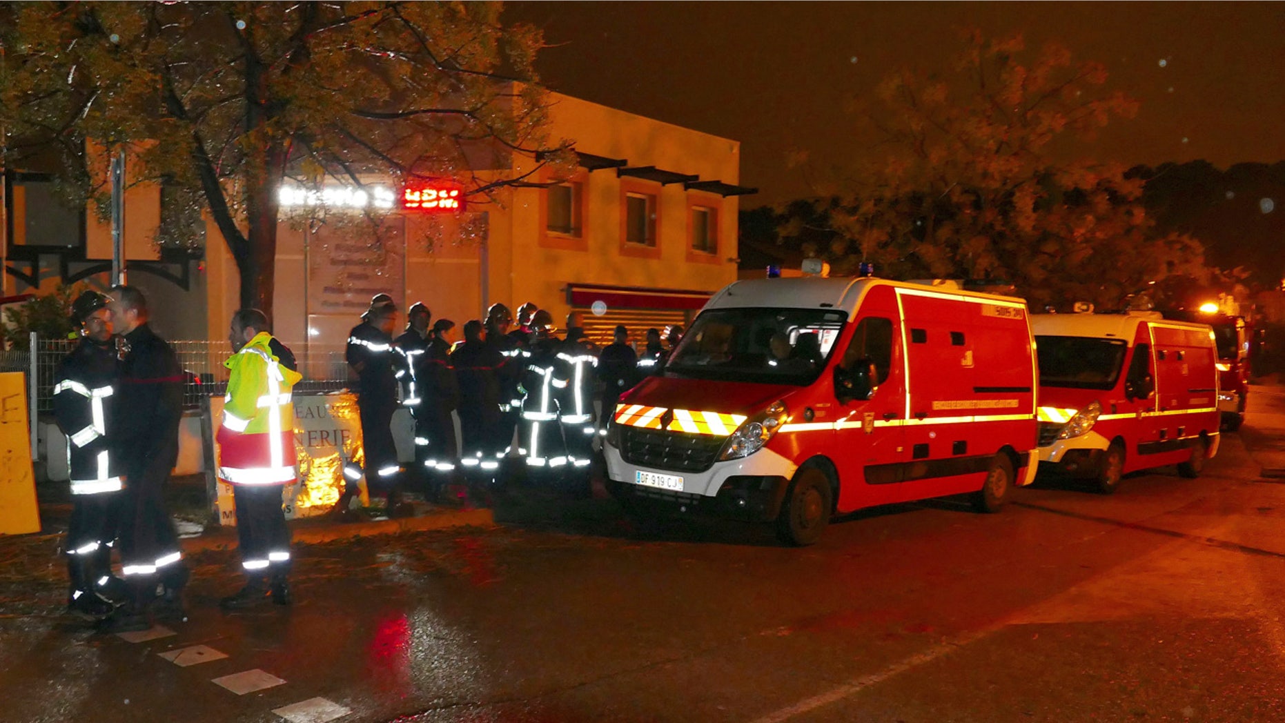 Firefighters and ambulances are seen in the village of Montferrier-sur-Lez, southern France, Friday, Nov. 25, 2016.