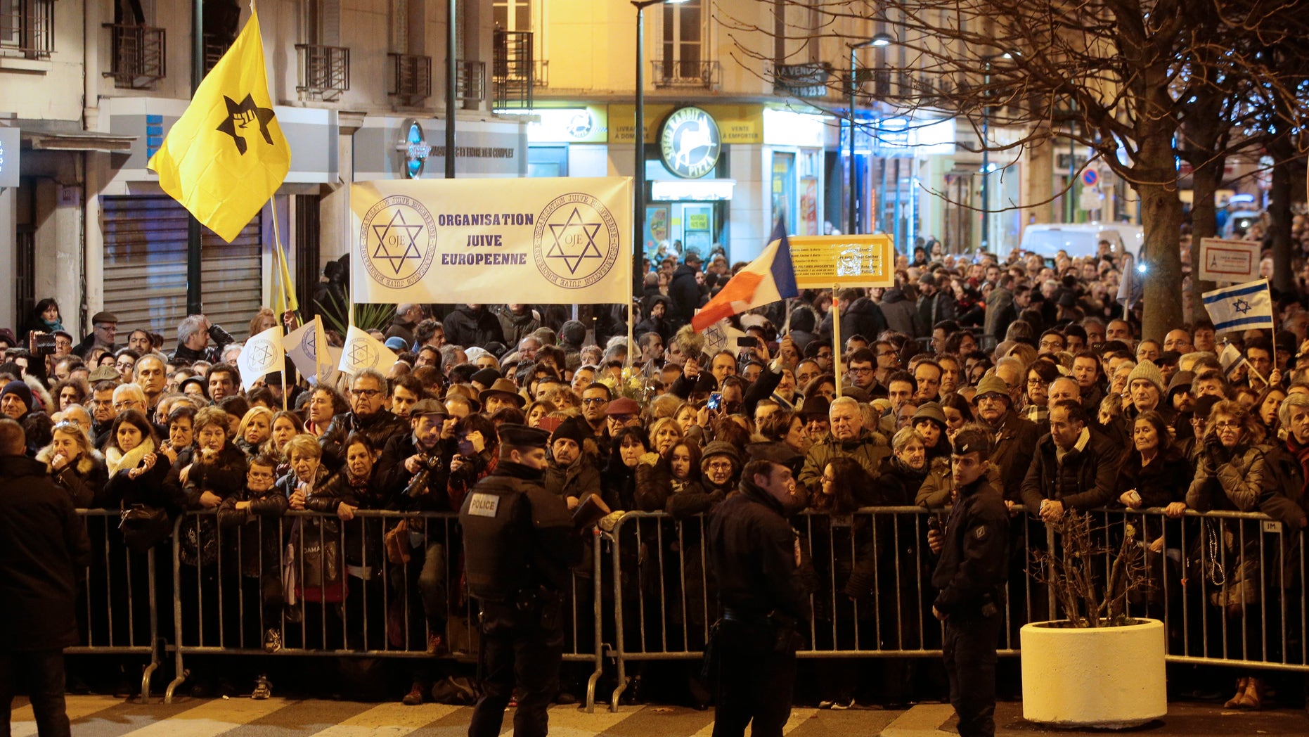 People gather at a ceremony near the kosher supermarket Hyper Cacher in Paris.