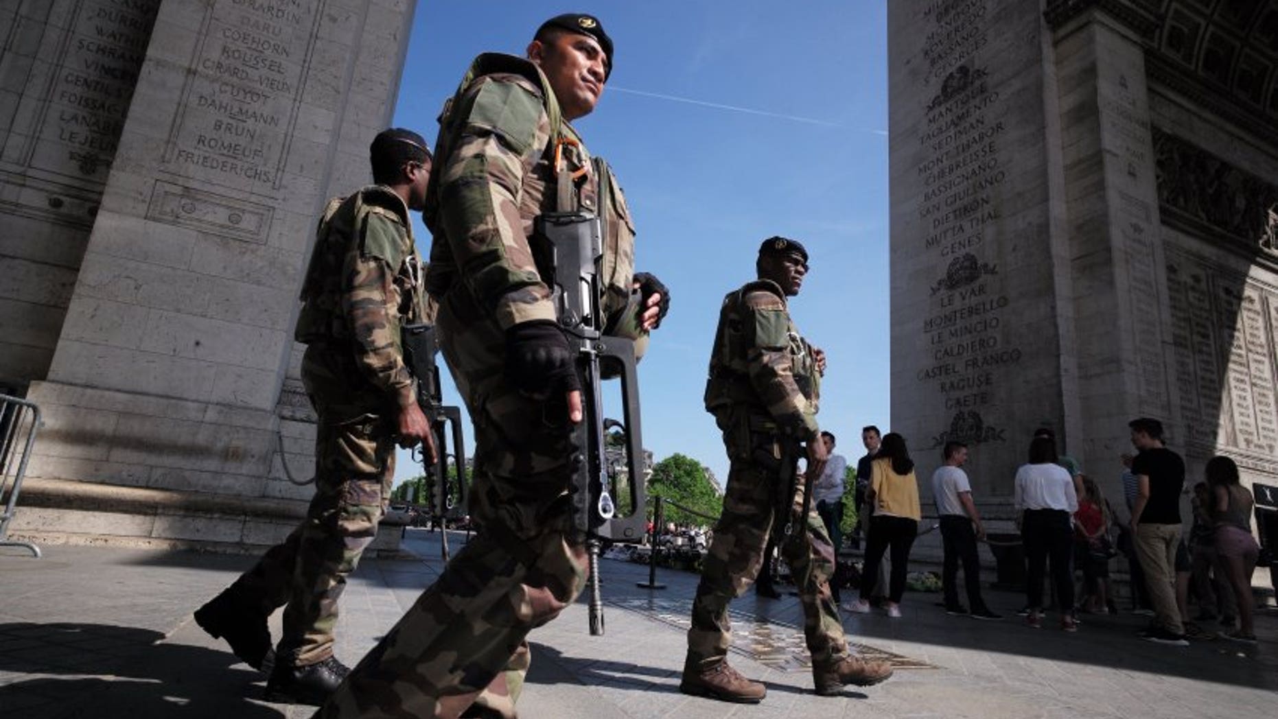 Soldiers near the Eiffel tower in Paris on Thursday, one day before the start of Euro 2016.