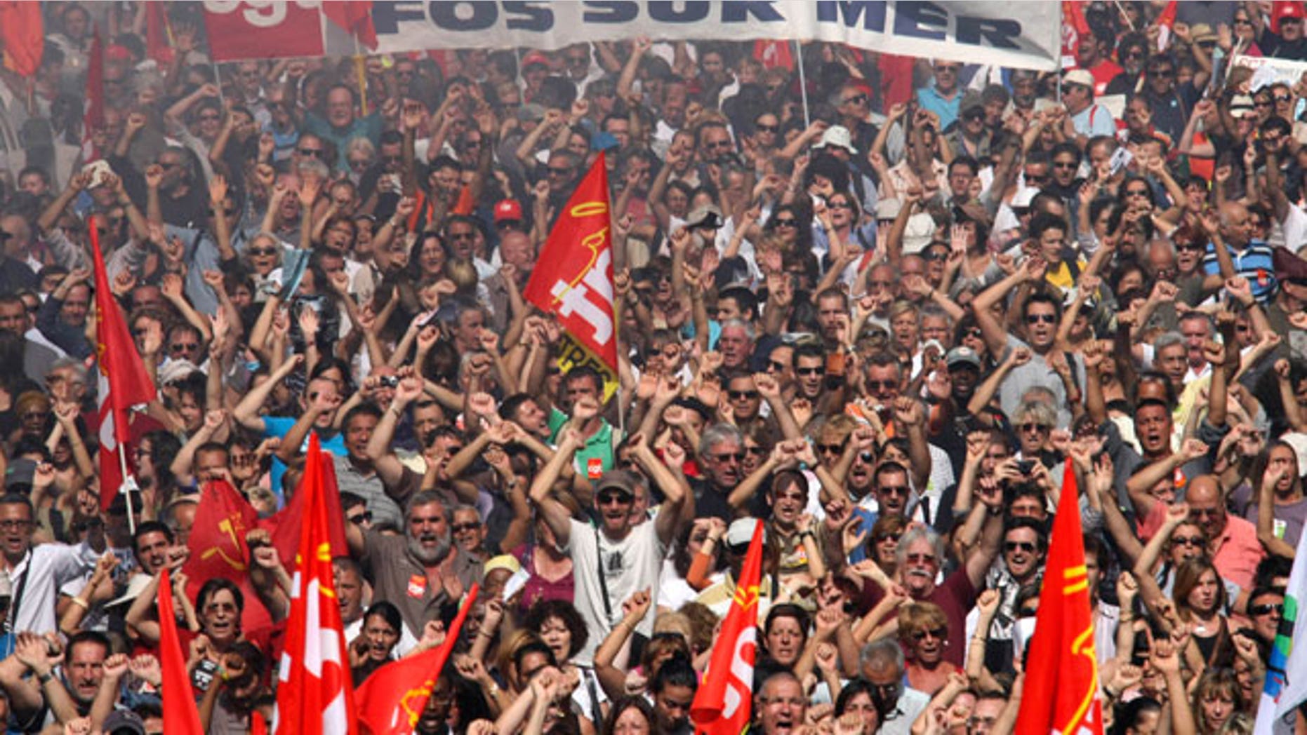 People march during a protest, in Marseille, southern France, Thursday, Sept. 23, 2010. French commuters squeezed onto limited trains or fought for rare parking spots Thursday as a second round of strikes against President Nicolas Sarkozy's plan to raise the retirement age to 62 hobbled trains, planes and schools across the country.