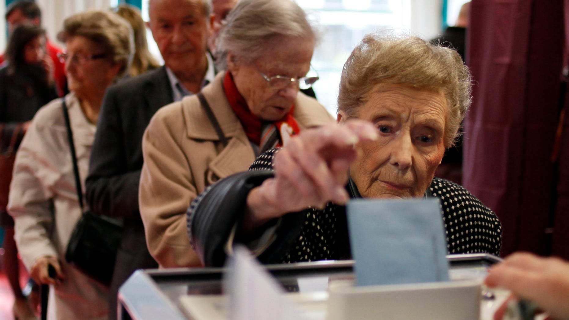 April 22, 2012: A woman casts her ballot during the first round of the French elections in Lille, northern France.