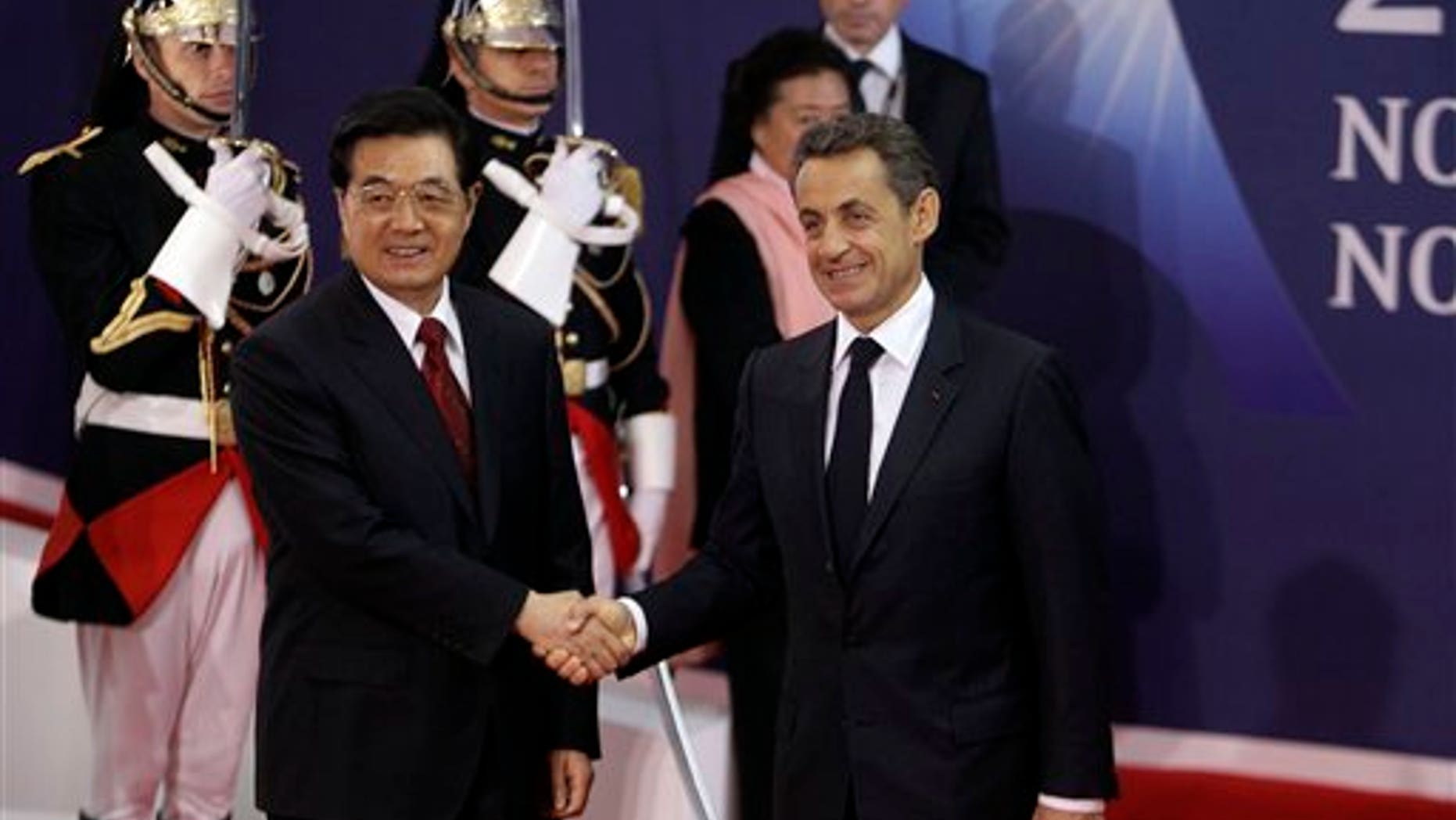 Nov. 2, 2011: French President Nicolas Sarkozy, right, shakes hands with China's President Hu Jintao during arrivals for the G20 summit in Cannes, France.
