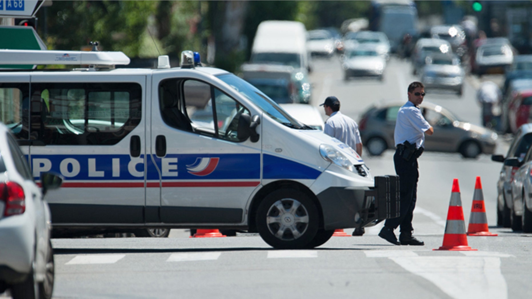 June 20, 2012: Police officers secure the area after a gunman took four people hostage in a bank in the southern French city of Toulouse and fired a shot, police said.