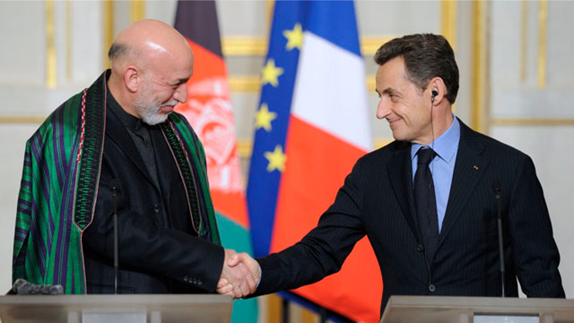 Jan. 27, 2012: Afghan president Hamid Karzai, left, shakes hands with French President Nicolas Sarkozy, right, following a news conference at the Elysee palace in Paris.