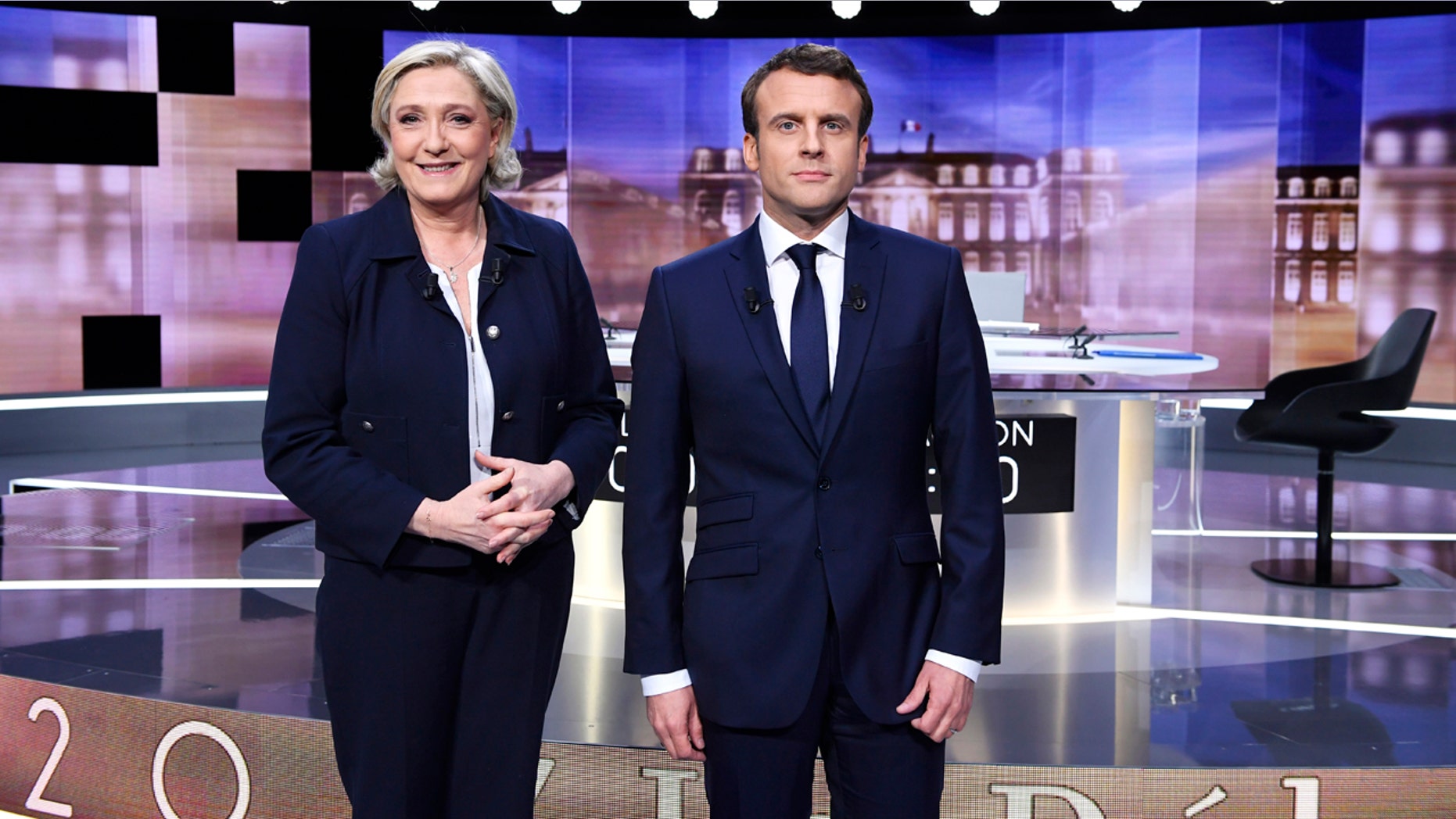 French presidential election candidate for the far-right Front National party, Marine Le Pen, left, and French presidential election candidate for the En Marche ! movement, Emmanuel Macron, pose prior to the start of a live broadcast face-to-face televised debate in La Plaine-Saint-Denis, north of Paris, France, Wednesday, May 3, 2017 as part of the second round election campaign. Pro-European progressive Emmanuel Macron and far-right Marine Le Pen are facing off in their only direct debate before Sunday's presidential runoff election. (Eric Feferberg/Pool Photo via AP)