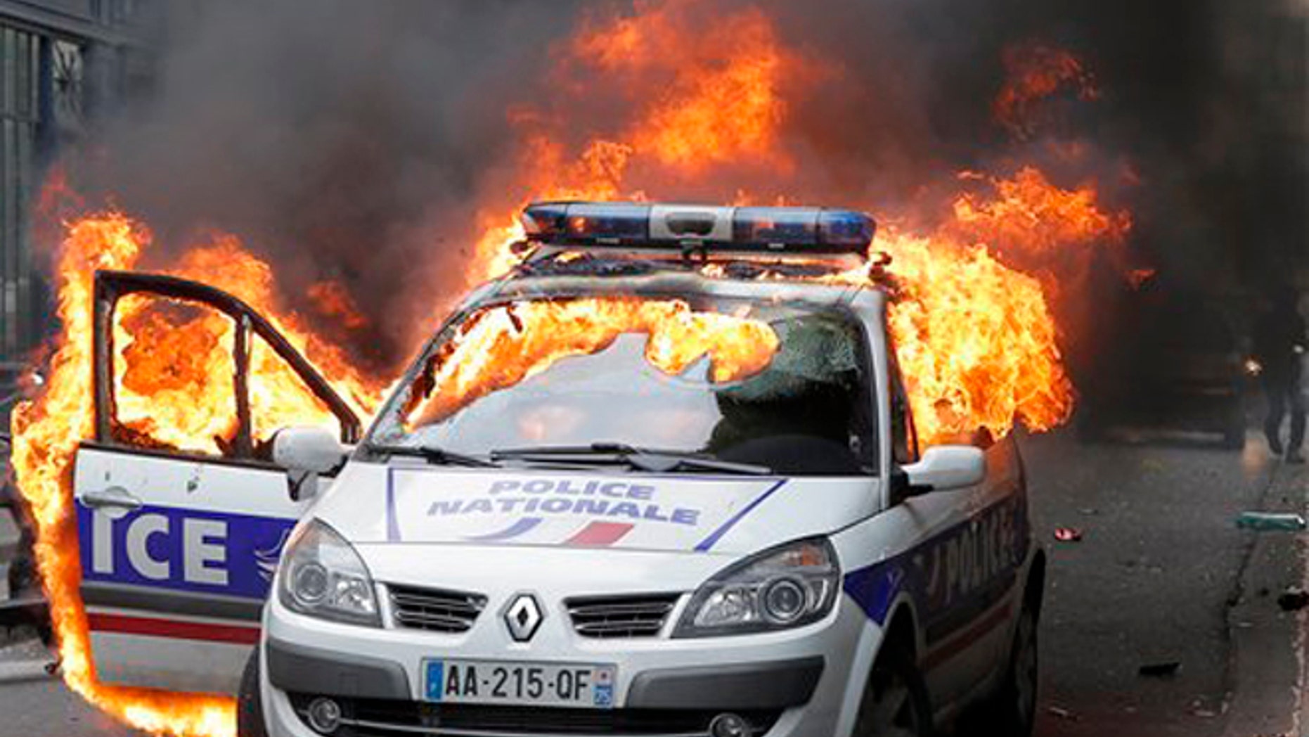 In this Wednesday, May 18, 2016 file picture, A police car burns during clashes while police forces gather to denounce the hatred and violence they say is being repeatedly directed at them during near-daily protests against labor reforms, in Paris.