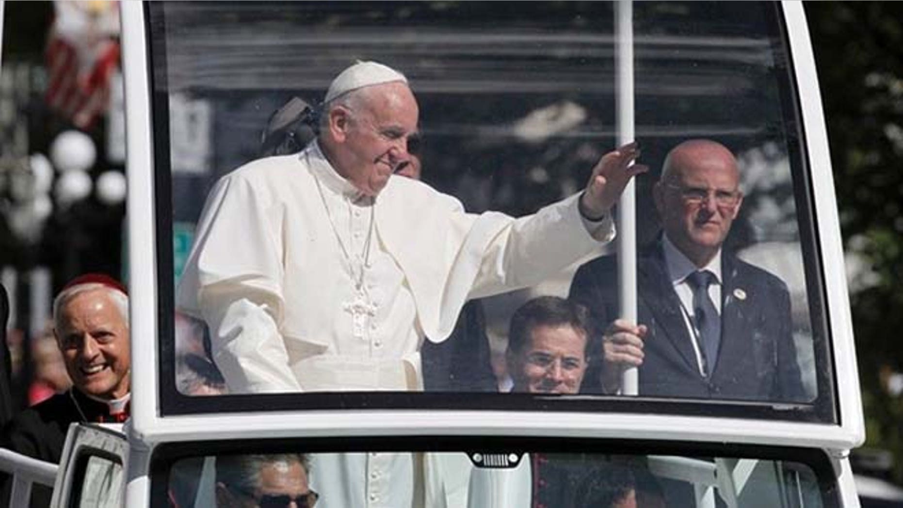 Pope Francis waves from the popemobile during a parade in Washington. (AP)