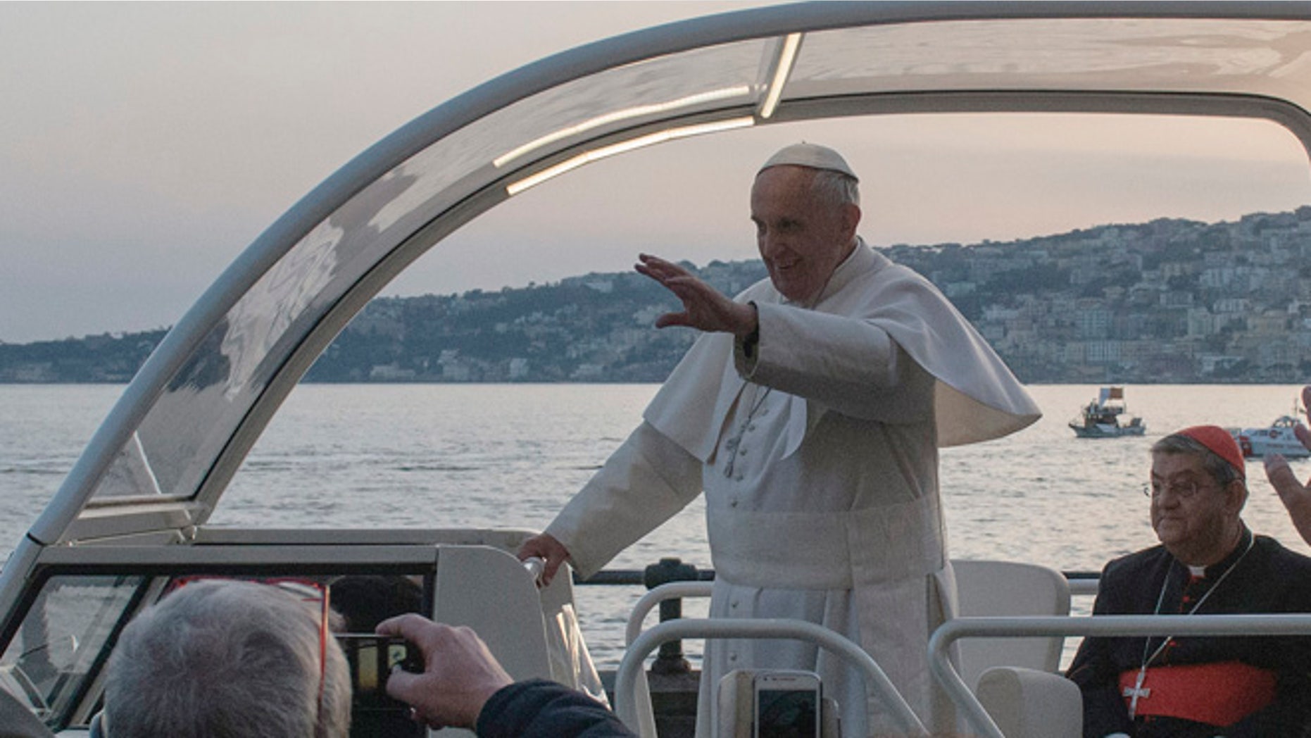Mar. 21, 2015: Pope Francis waves to faithful as he leaves after a meeting with young people in Naples, Italy. (AP)