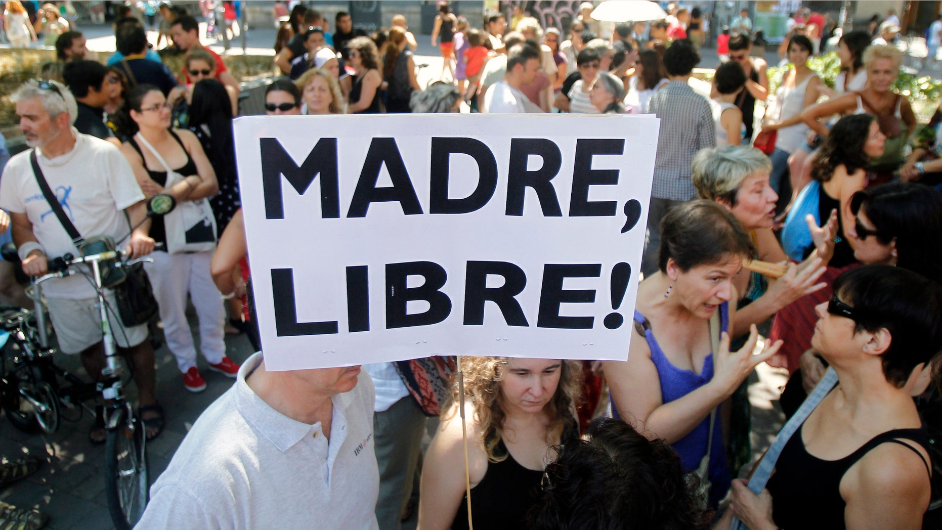 A protester shows a banner that reads: "Free Mother" during the protest against abortion law reform in Madrid, Spain.