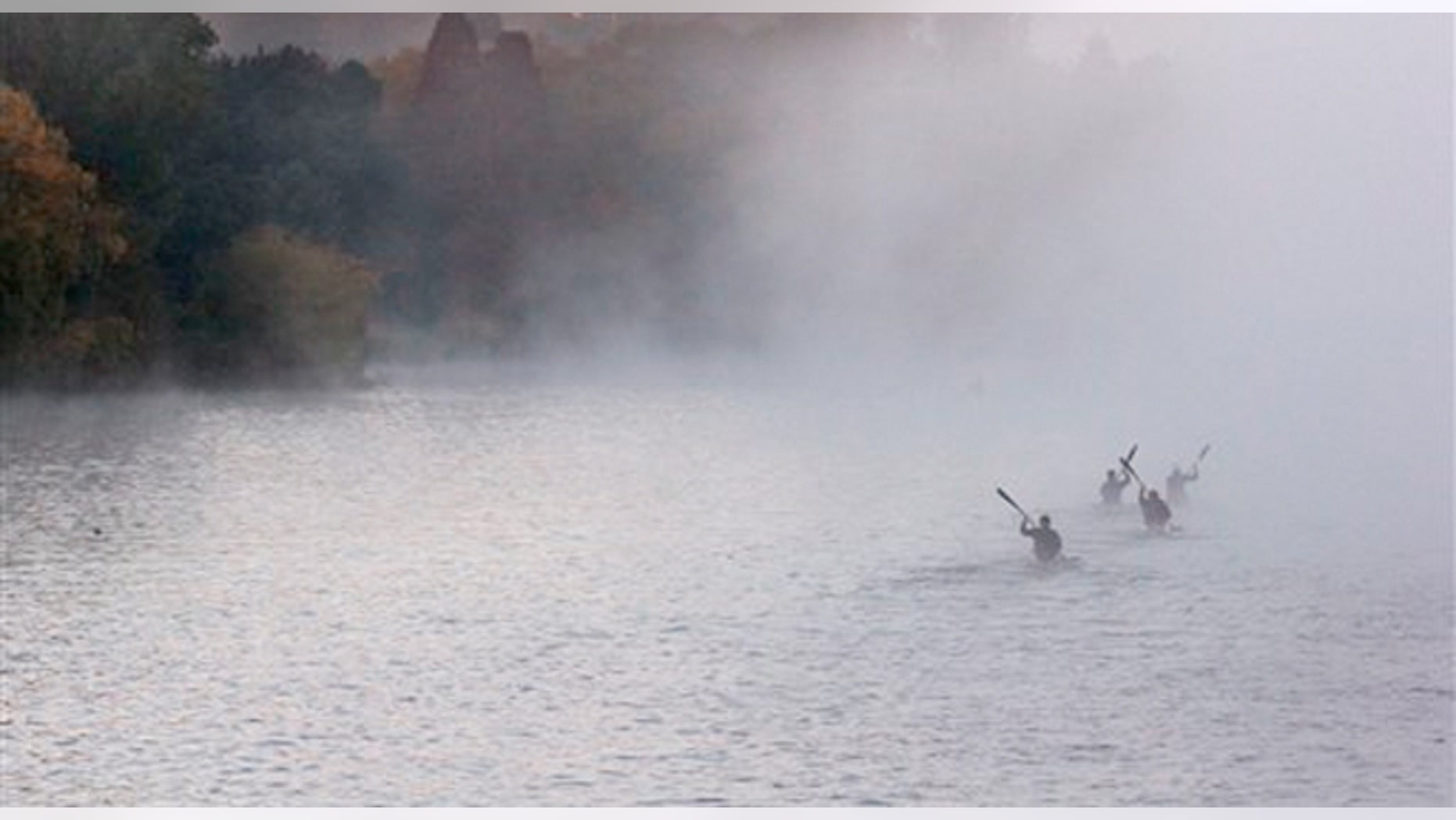 Paddlers row in the early morning autumn mist on the Emmarentia Dam in Johannesburg.