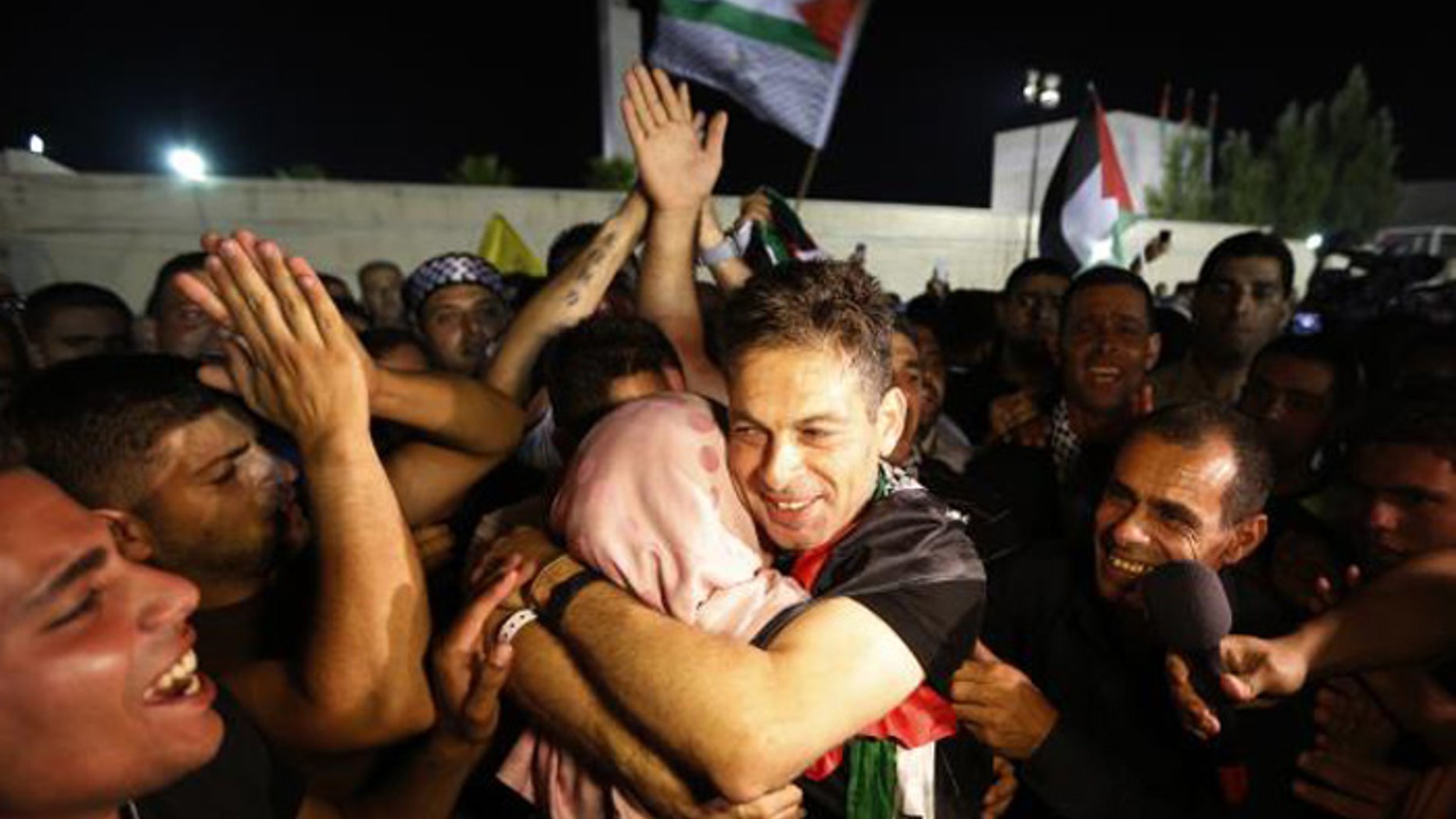 A freed Palestinian prisoner hugs a relative after his arrival in the West Bank city of Ramallah last month. (Reuters)