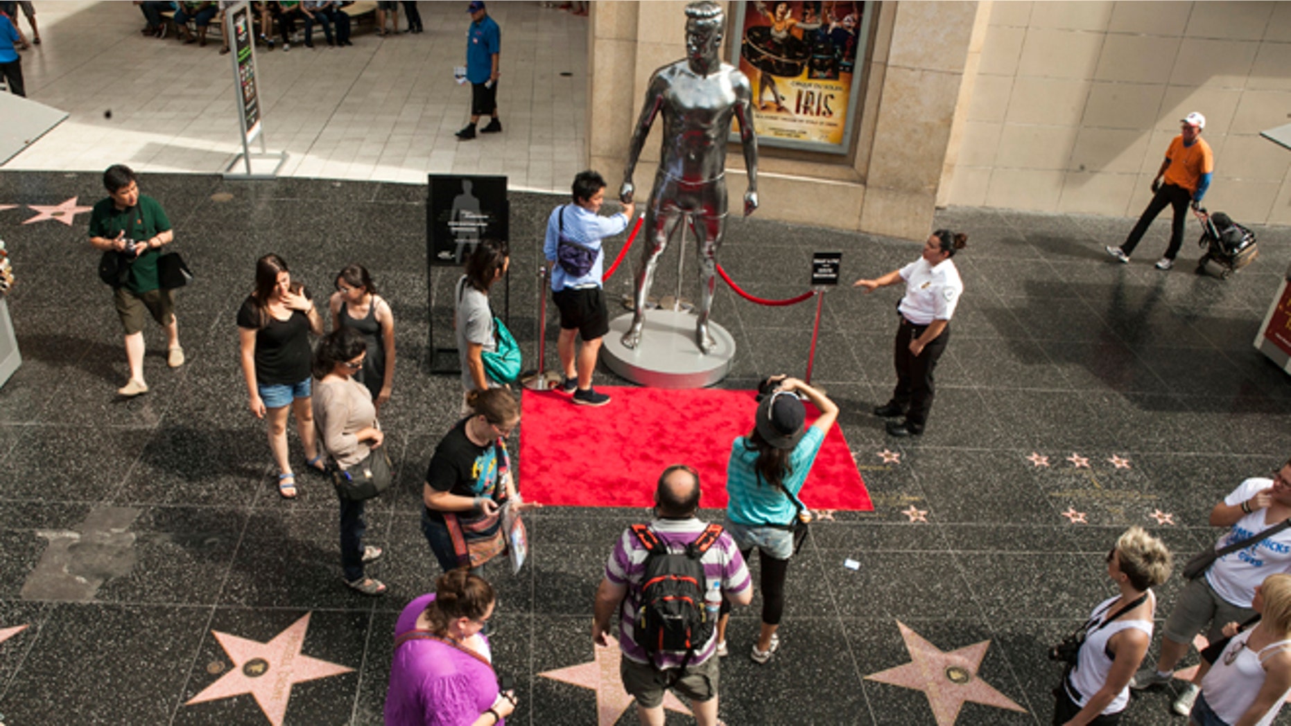 Aug. 17, 2012: Tourists take photos with a 10-foot statue created and modeled after English soccer star David Beckham displayed in the Hollywood section of Los Angeles.