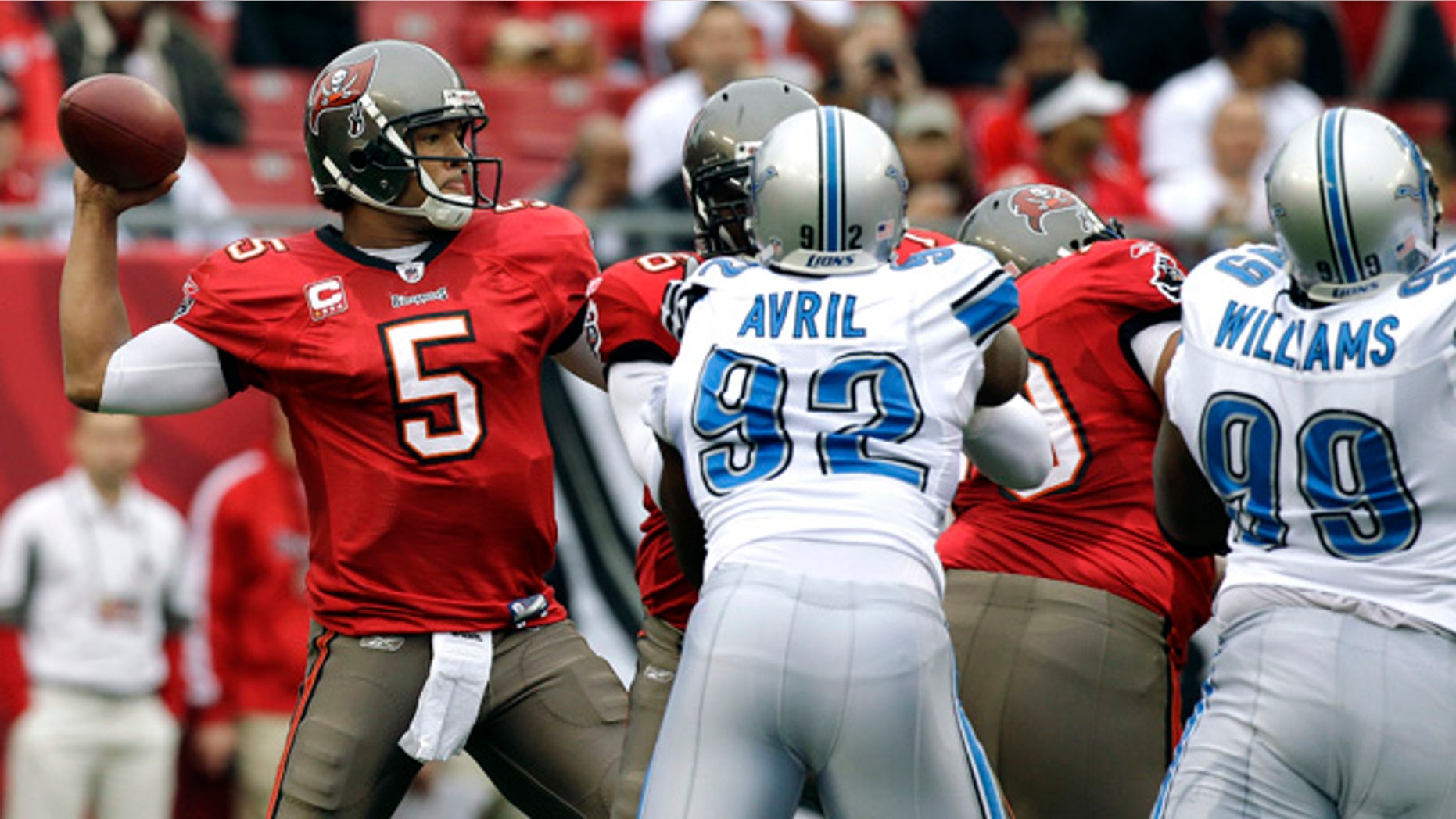 Dec. 19: Tampa Bay Buccaneers quarterback Josh Freeman (5) throws as Detroit Lions defensive end Cliff Avril (92) and defensive tackle Corey Williams (99) pursue during the first quarter of an NFL football game in Tampa, Fla. (AP)