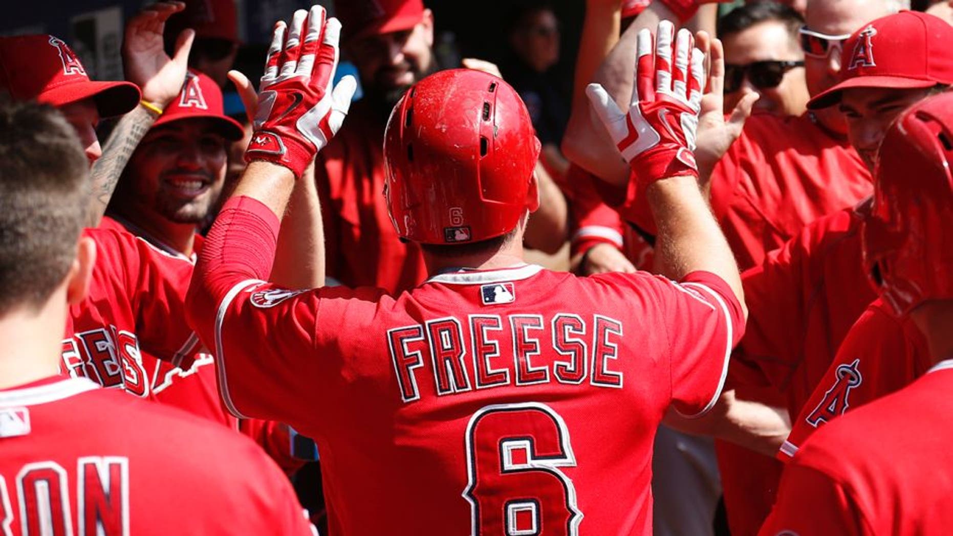 Oct 3, 2015; Arlington, TX, USA; Los Angeles Angels third baseman David Freese (6) celebrates his run with teammates against the Texas Rangers during the fifth inning of a baseball game at Globe Life Park in Arlington. Mandatory Credit: Jim Cowsert-USA TODAY Sports