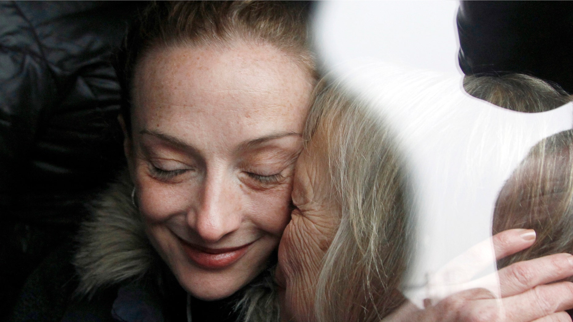 Frenchwoman Florence Cassez, left, is kissed by her mother Charlotte after landing at Roissy airport, north of Paris, Thursday, Jan.24, 2013. Cassez, who spent seven years in prison in Mexico on kidnapping charges returned to a heroes welcome in Paris on Thursday, declaring she had been cleared by the Mexican court that ordered her freed. (AP Photo/Christophe Ena)