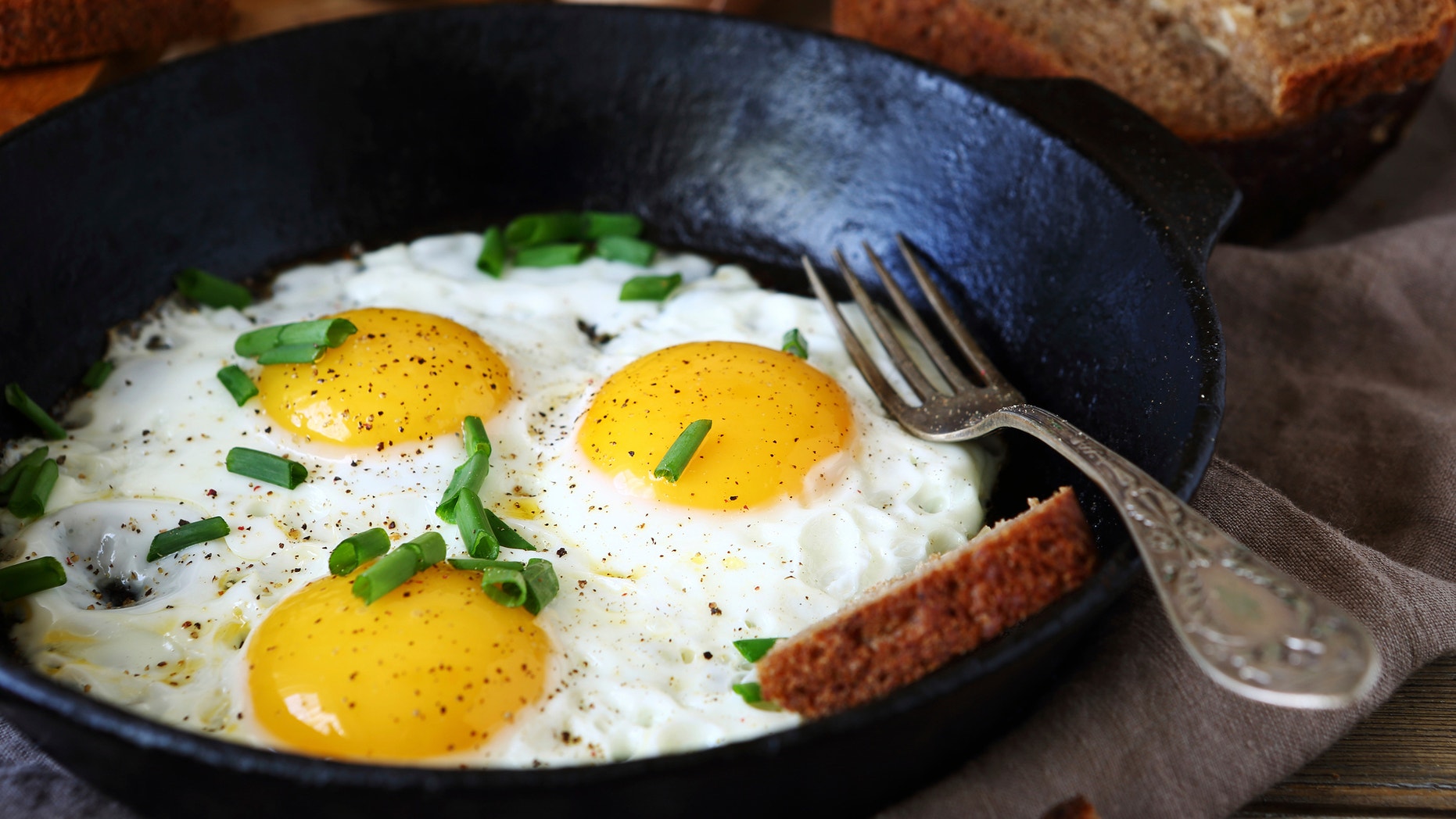 Hot fried eggs in a pan, close up