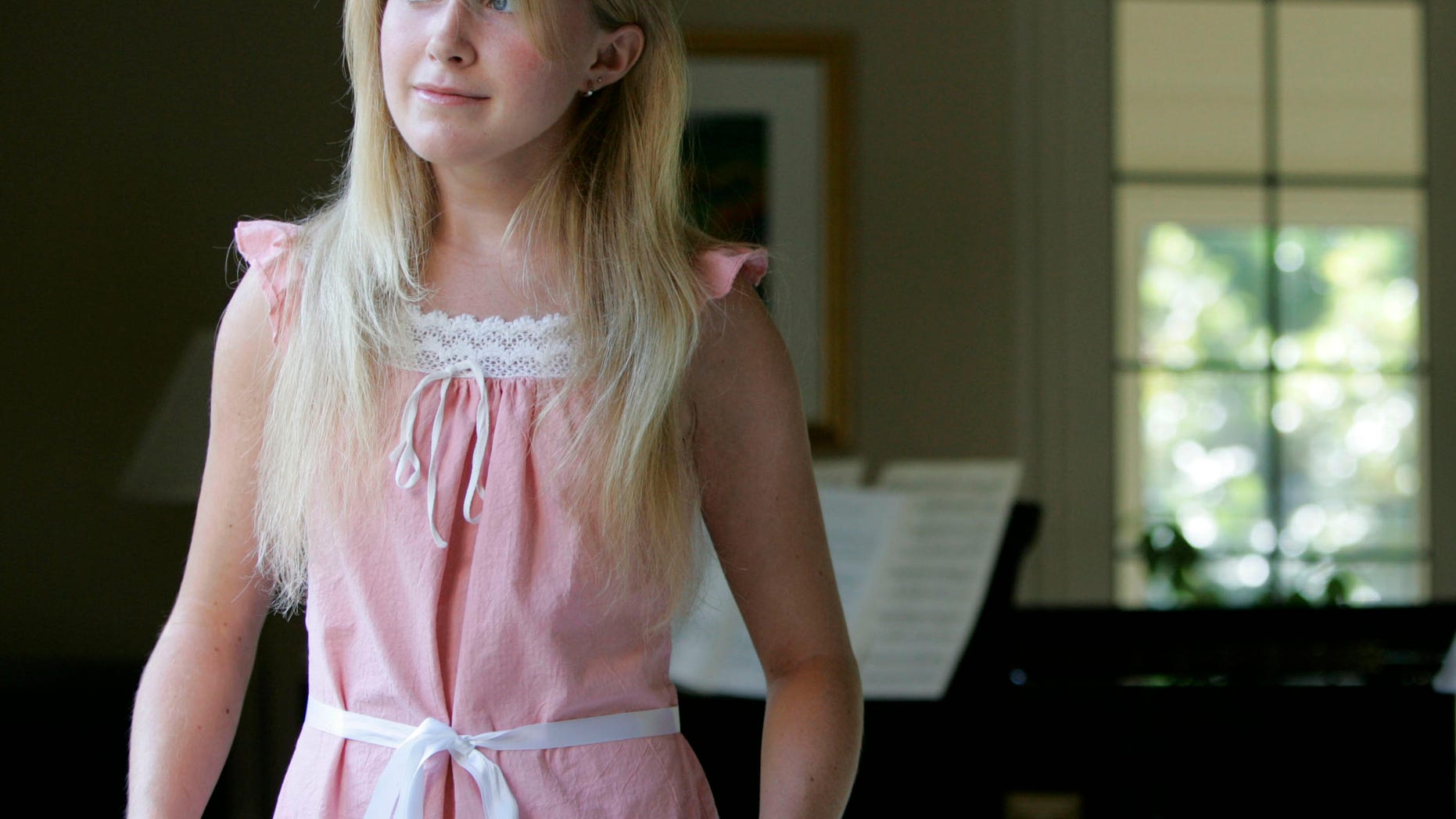 In this photo taken in 2005, Amy Winn poses in her home in Eugene, Ore. Winn, the youngest daughter of former University of Oregon President Dave Frohnmayer and his wife, has died Sunday, Oct. 1, 2016, of a rare genetic disorder. She is the third Frohnmayer child to die of Fanconi anemia. She was 29. (Kevin Clark/The Register-Guard via AP)