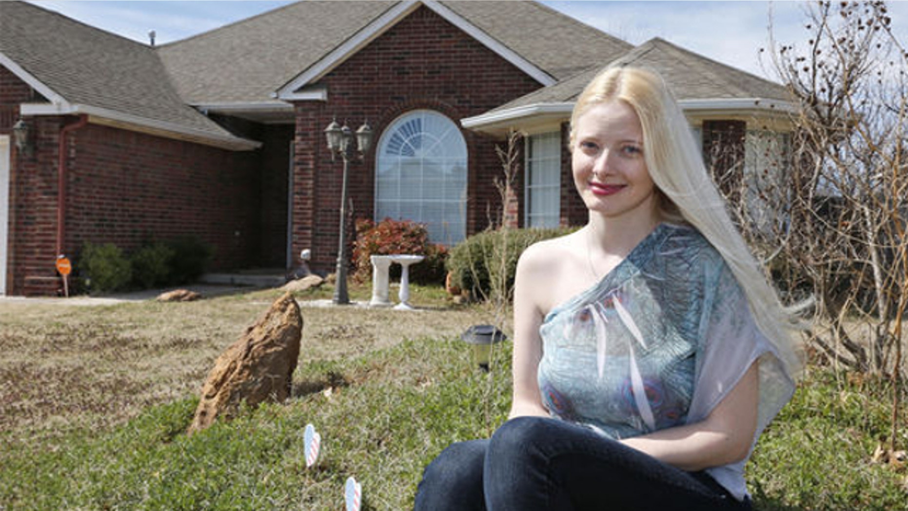 March 17, 2014: Jennifer Hunt poses for a photo outside her home in Noble, Okla. Hunt, whose husband was a soldier killed in the Fort Hood shooting, could get relief from a $6,000 tax bill under a measure Oklahoma legislators are considering that would grant some families benefits similar to those given after acts of terrorism.