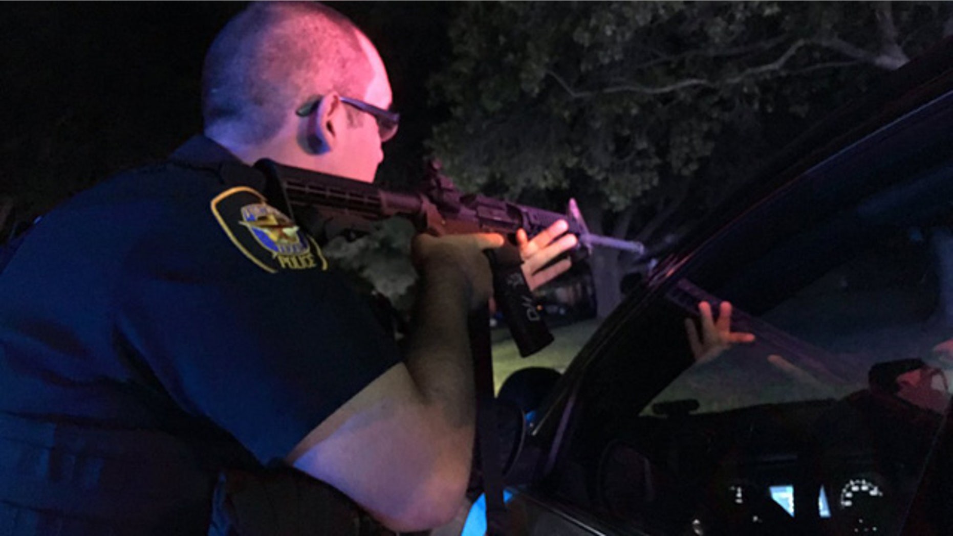 Sept. 16, 2016: A Fort Worth police officer draws his gun at the scene of a shooting that injured two officers.