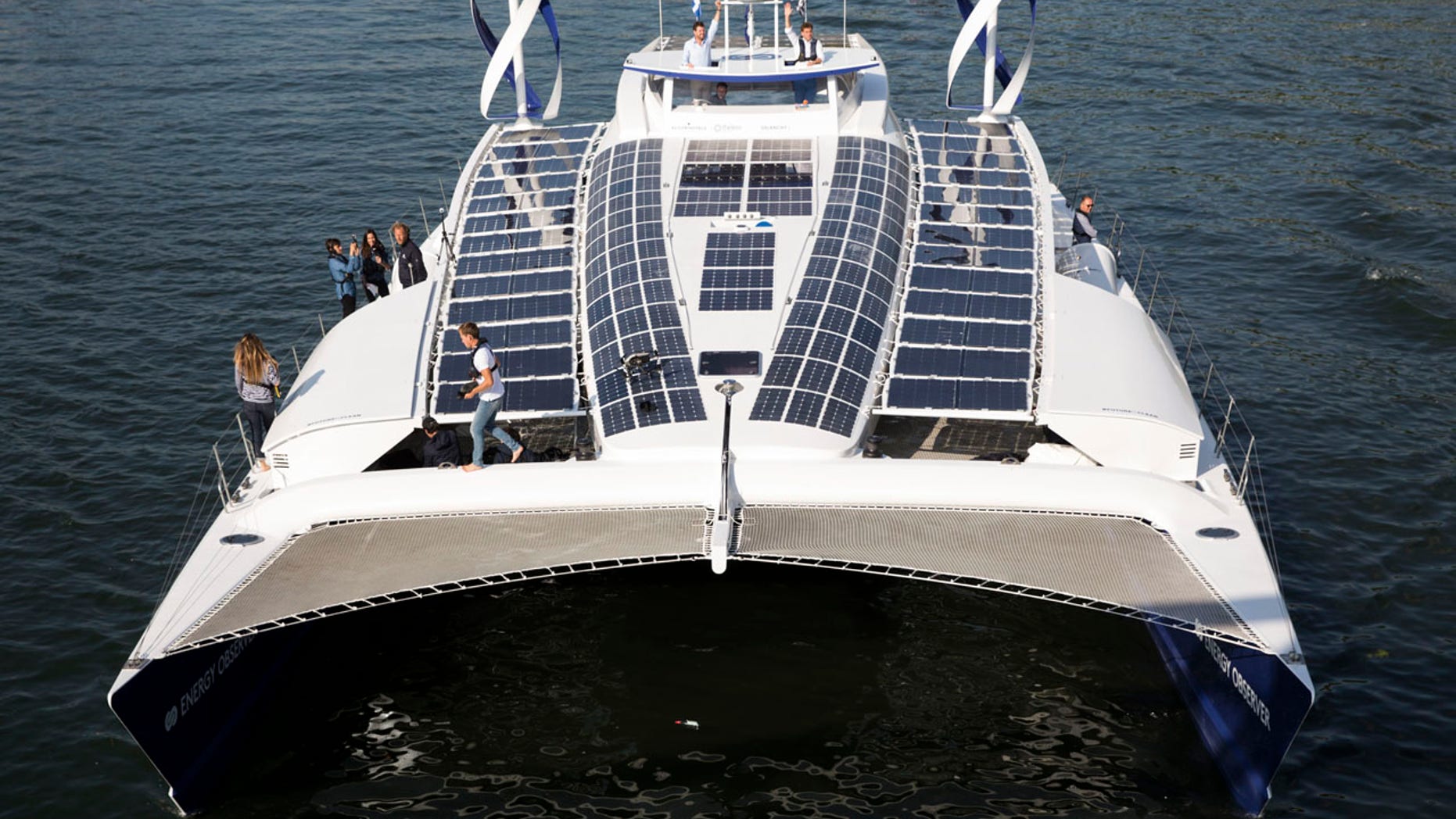 In this Tuesday, July 4, 2017 file photo, the Energy Observer, a former race boat turned into a autonomous navigation with hydrogen, sails on the Seine river in Paris.