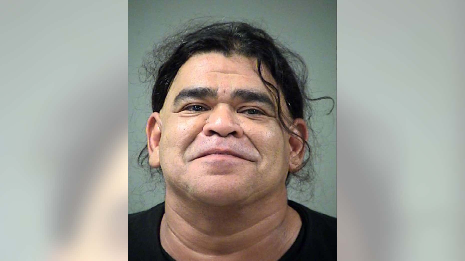 Motel employee Manuel Romo, 49, tipped off an unnamed fugitive about police surveillance, authorities said.
