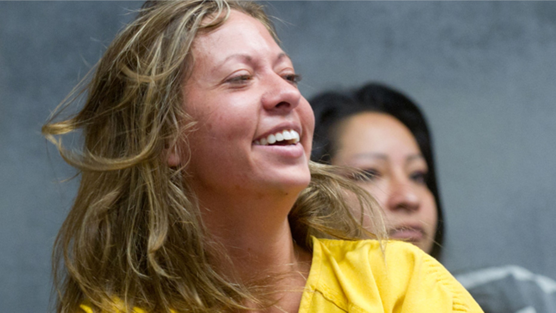 Aug. 11: Lee Grace Dougherty, 29, laughs at the Pueblo County Sherrif's Office detention center.