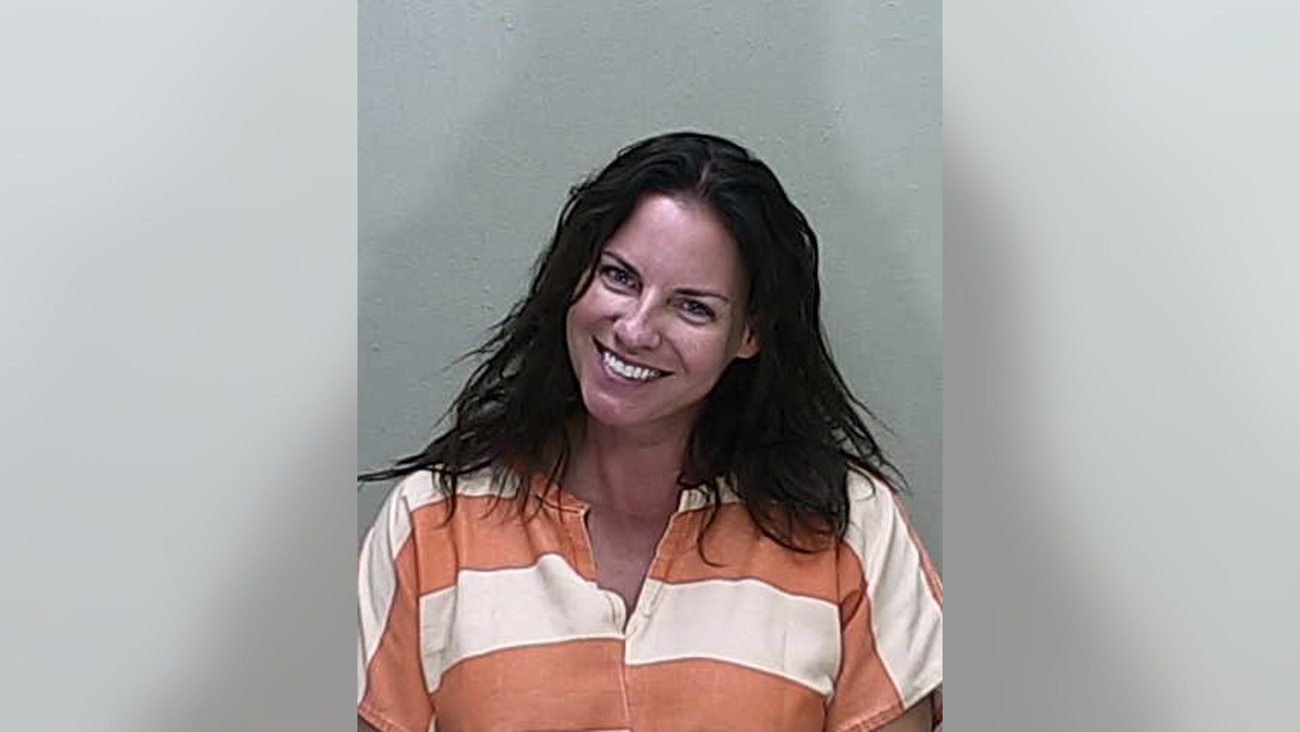 Angenette Welk, 44, smiling in her mugshot following a DUI crash that killed a mother days later, officials say.