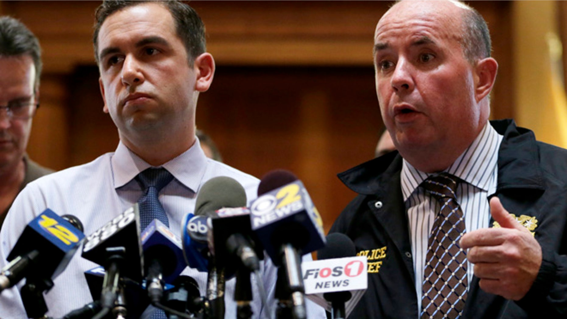 July 13, 2014: Jersey City Police Chief Robert Cowan, right, talks while standing next to Mayor Steven Fulop during a news conference talking about an early morning shooting which lead to the killings of a suspect and a Jersey City Police Department officer.