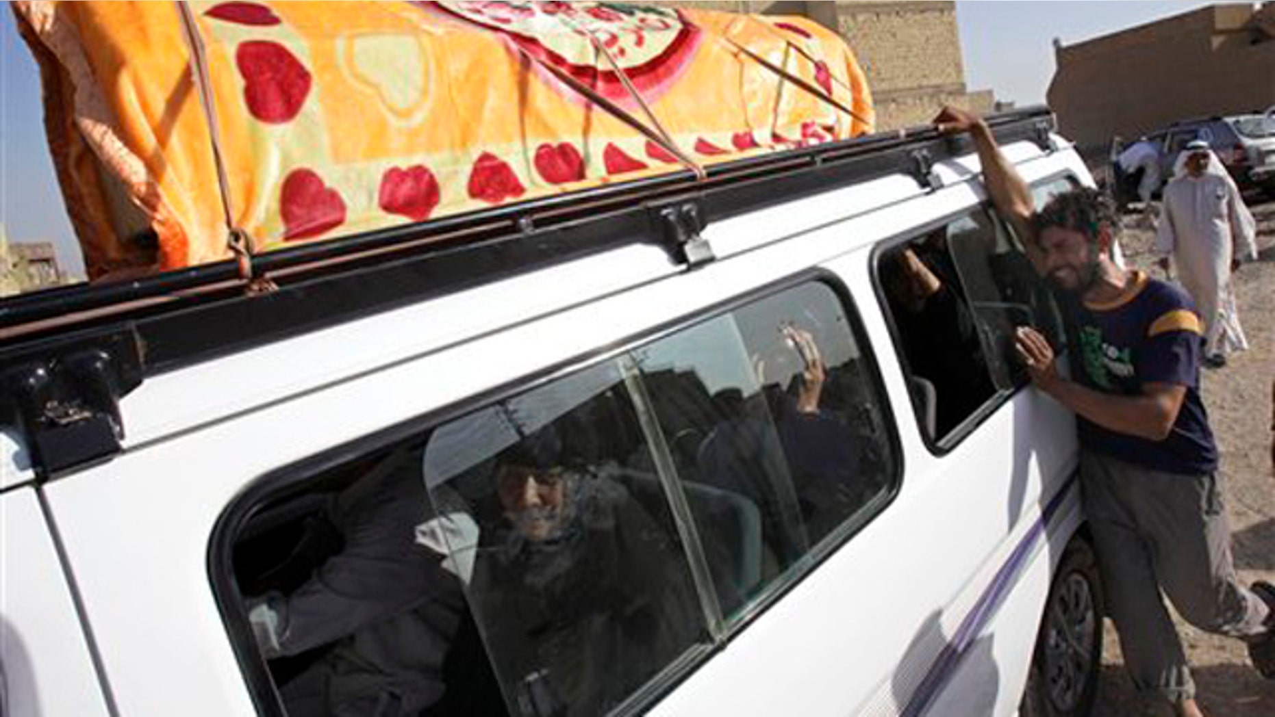 Friends and relatives of Amir Fadhil, 30, grieve during his funeral procession in Baghdad, Iraq, Monday, Aug. 29, 2011.