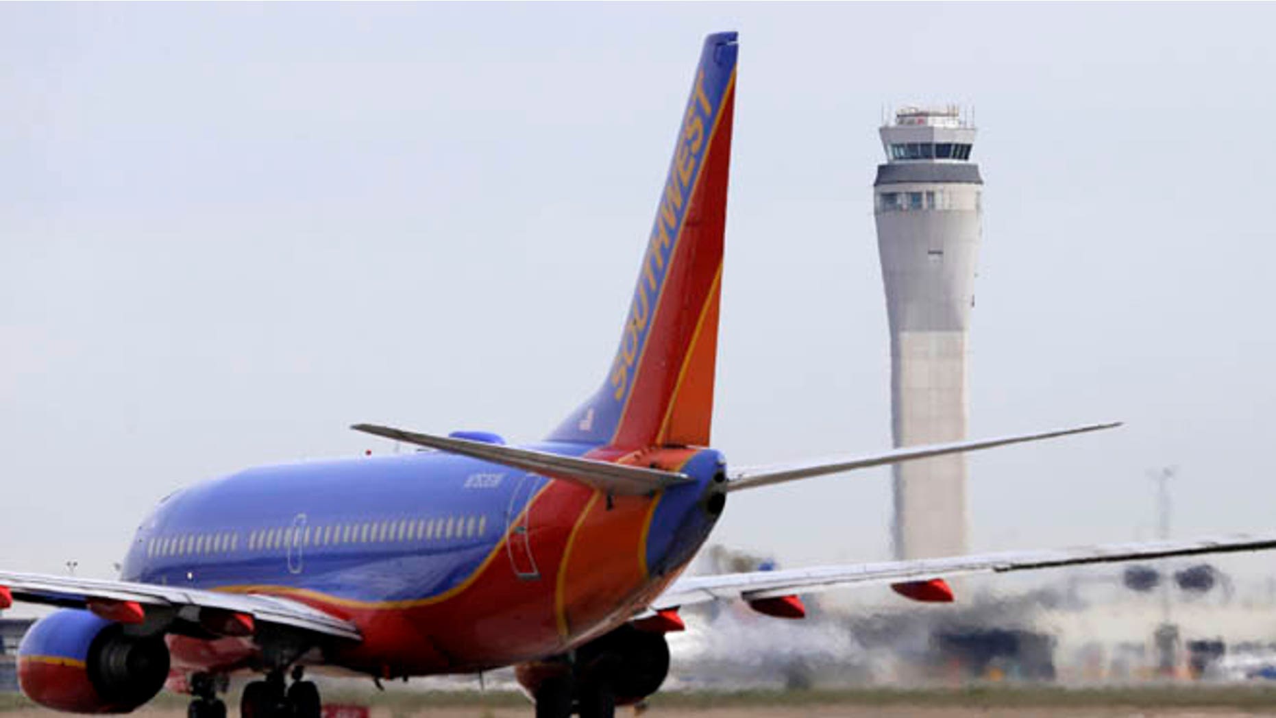 This photo taken April 23, 2013 shows a Southwest airlines jet waiting to depart in view of the air traffic control tower at Seattle-Tacoma International Airport in Seattle.
