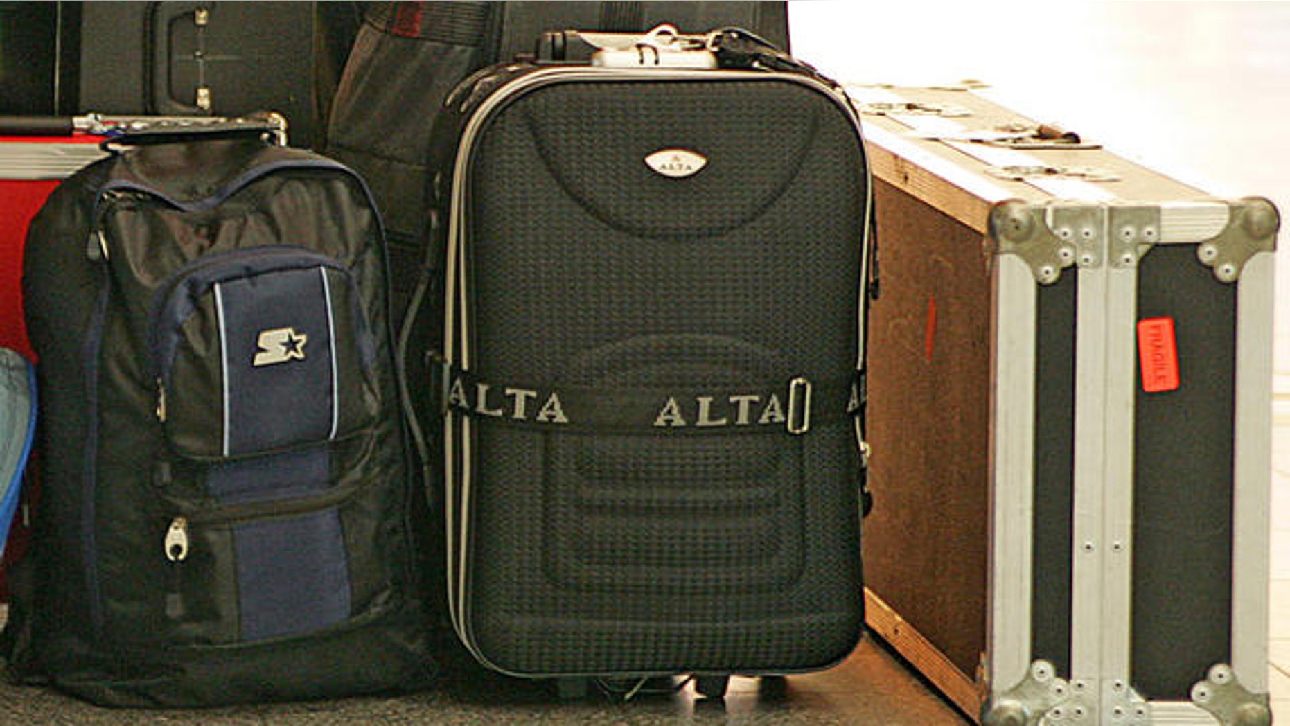 A traveler sleeps next to some luggage at LaGuardia Airport in New York, Friday, Aug. 11, 2006. Passengers in the United States are facing heightened security and delays at airports today after authorities in London uncovered a terror plot yesterday aimed at airlines traveling from Britain to the U.S. (AP Photo/Ed Betz)