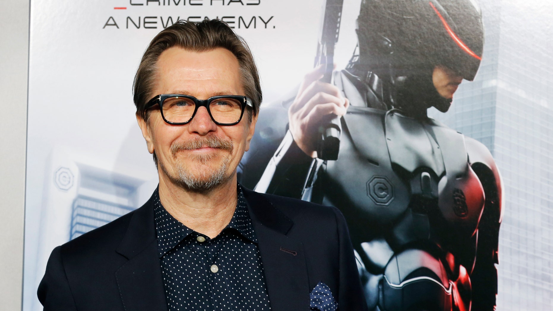 Actor Gary Oldman one of the stars of film "Robocop" arrive for the film's premiere in Hollywood, California February 10, 2014. REUTERS/Fred Prouser (UNITED STATES - Tags: ENTERTAINMENT PROFILE) - RTX18KF4
