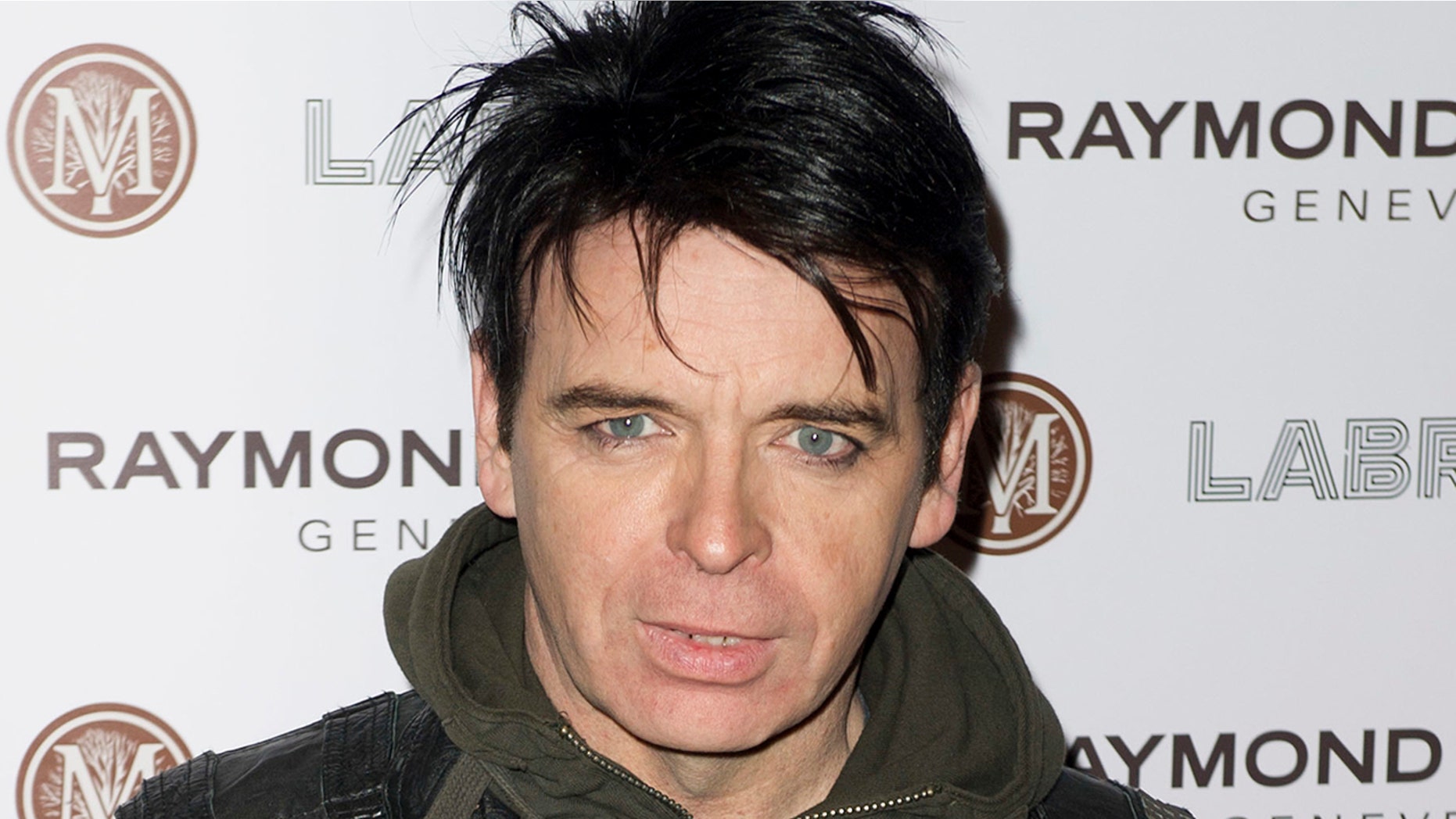 FILE - In this Jan. 26, 2012, file photo, British singer Gary Numan arrives for the Pre-Brit Awards Dinner at a London venue. Police say a tour bus carrying Numan struck and killed a 91-year-old man in Cleveland, on Monday, Sept. 24, 2018. Authorities say Numan's tour bus was making a right turn when it struck the victim as he walked in a crosswalk. (AP Photo/Jonathan Short, File)