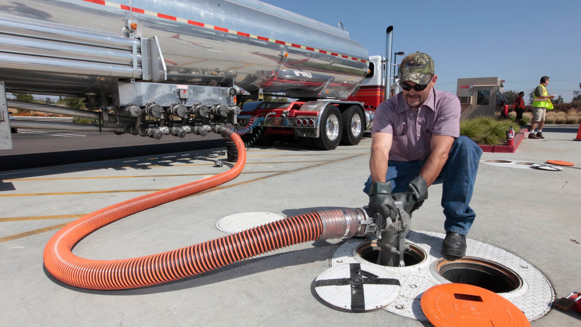 FILE: Thursday, Oct. 4, 2012: Lee Huffman removes a gas hose after delivering gas to the Costco gas station in Lodi, Calif.