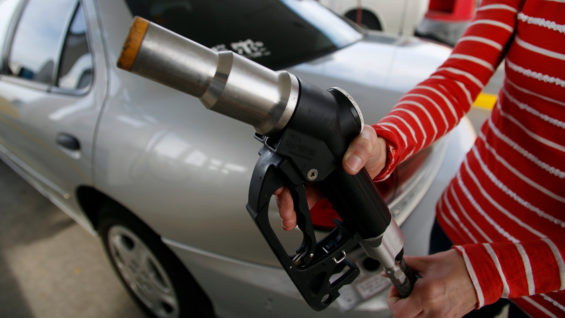 FILE: March 13, 2013: A motorist pumps gas at a Blu LNG filling station in Salt Lake City, Utah.