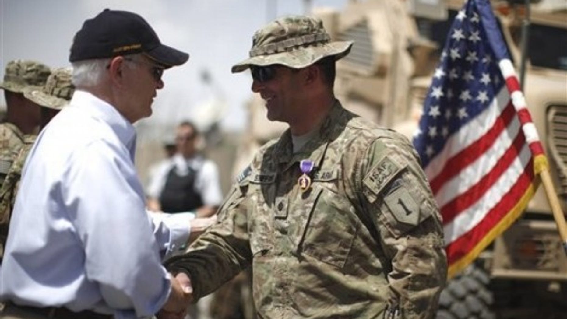 June 6: Defense Secretary Robert Gates shakes hands with U.S. Army LtCol. Alan Streeter after awarding him the Purple Heart Medal for wounds he received in combat during a ceremony at Combat Outpost Andar in Ghazni Province, Afghanistan.