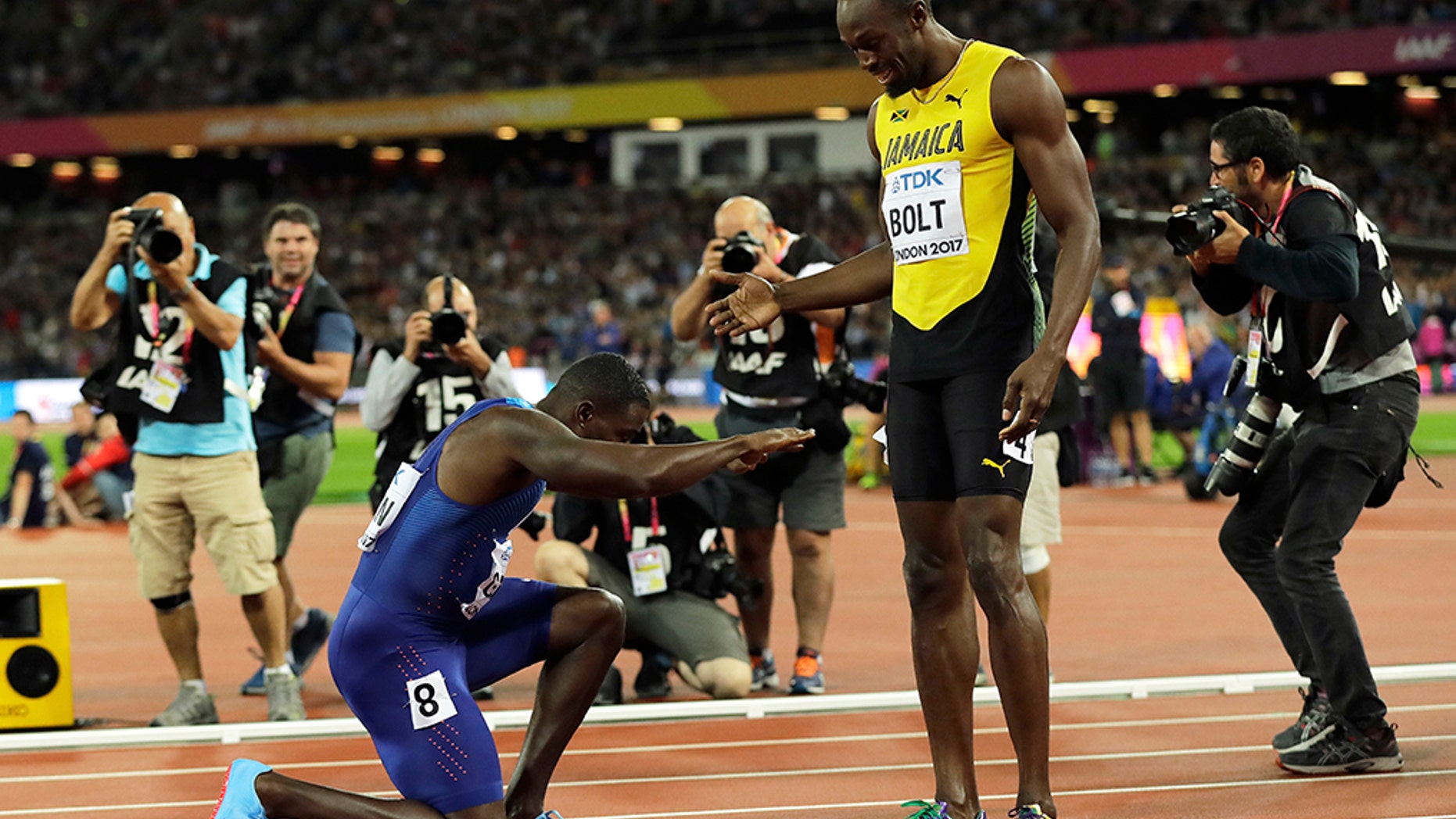 United States' Justin Gatlin bows to Jamaica's Usain Bolt after winning the Men's 100 meters final during the World Athletics Championships in London Saturday, Aug. 5, 2017. (AP Photo/Tim Ireland)