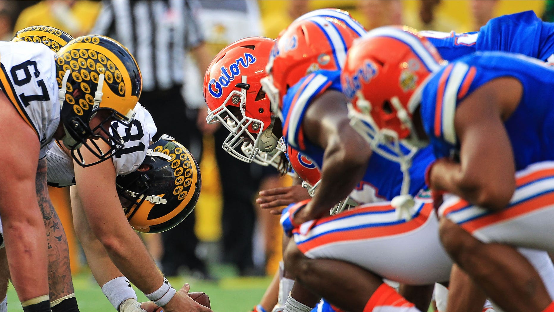 ORLANDO, FL - JANUARY 01: Michigan Wolverines and Florida Gators players line up before a snap during the second half of the Buffalo Wild Wings Citrus Bowl game at Orlando Citrus Bowl on January 1, 2016 in Orlando, Florida. (Photo by Rob Foldy/Getty Images)