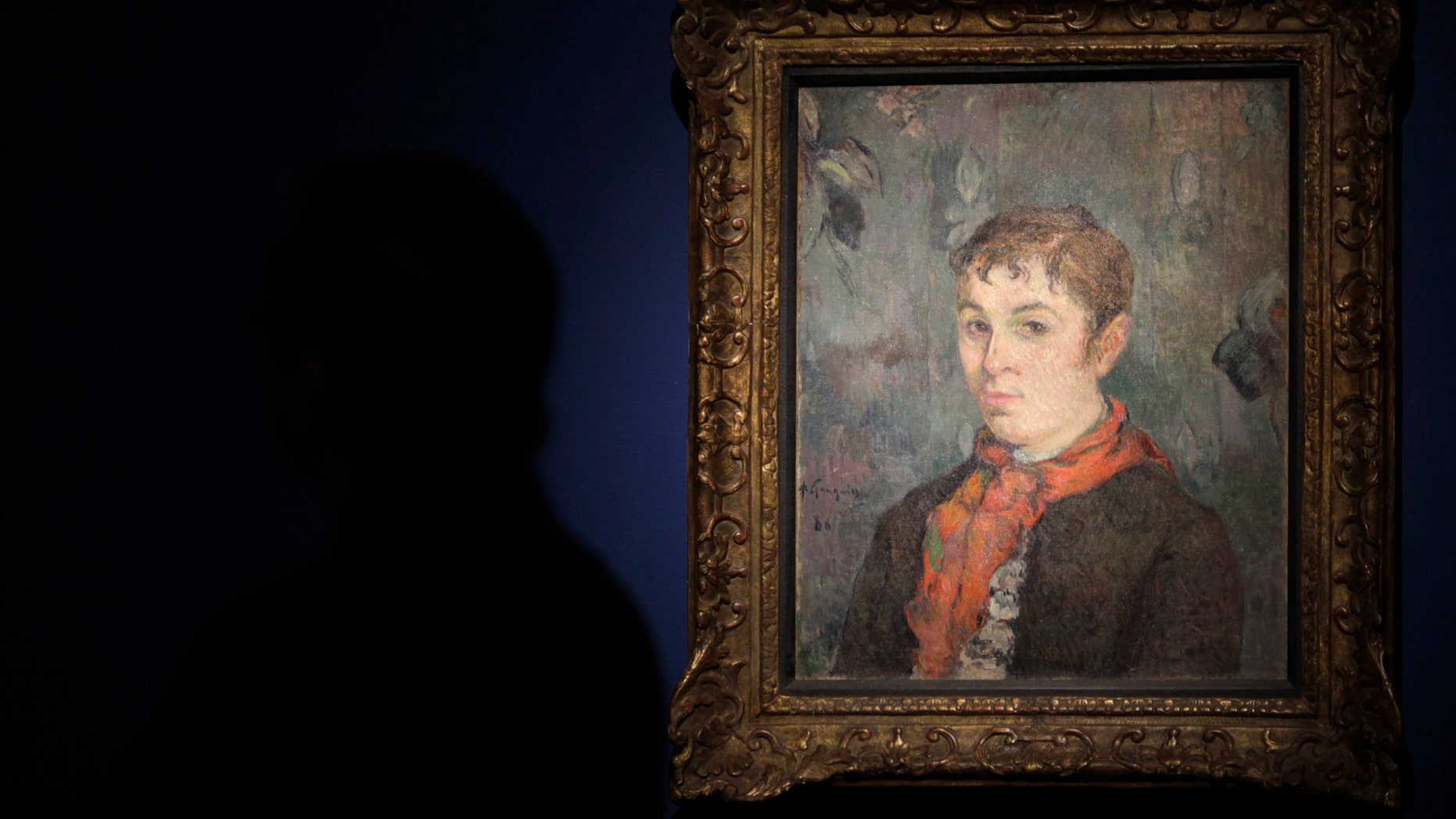 File photo - A man stands next to the painting "The boss's daughter" by French painter Paul Gauguin during a media presentation of the art exhibition "Paul Gauguin, the dream of Panama" at the Interoceanic Canal Museum in Panama city December 6, 2012. (REUTERS/Carlos Jasso)