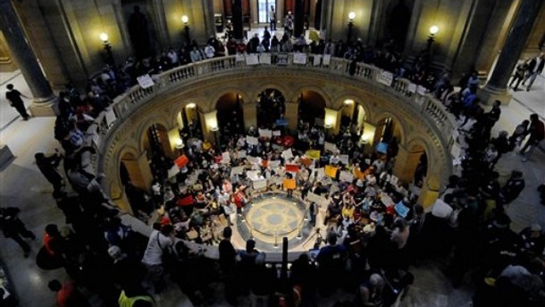 May 21: Demonstrators shout and wave signs in the State Capitol rotunda during a Peoples Rally for a Fair Minnesota as the state Legislature debated gay marriage near the end of its session.