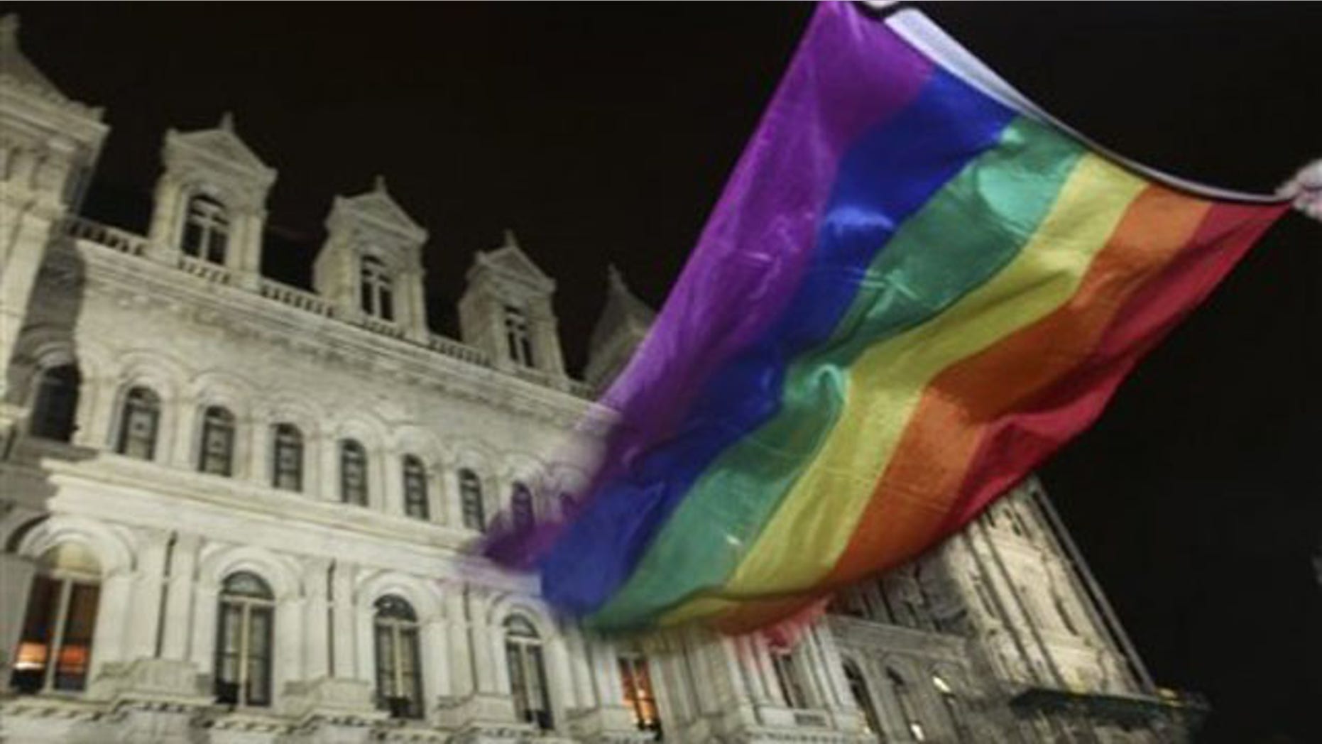 June 24, 2011: A pride flag waves outside the Capitol in Albany, N.Y., after the state Senate passed a bill legalizing same-sex marriage.